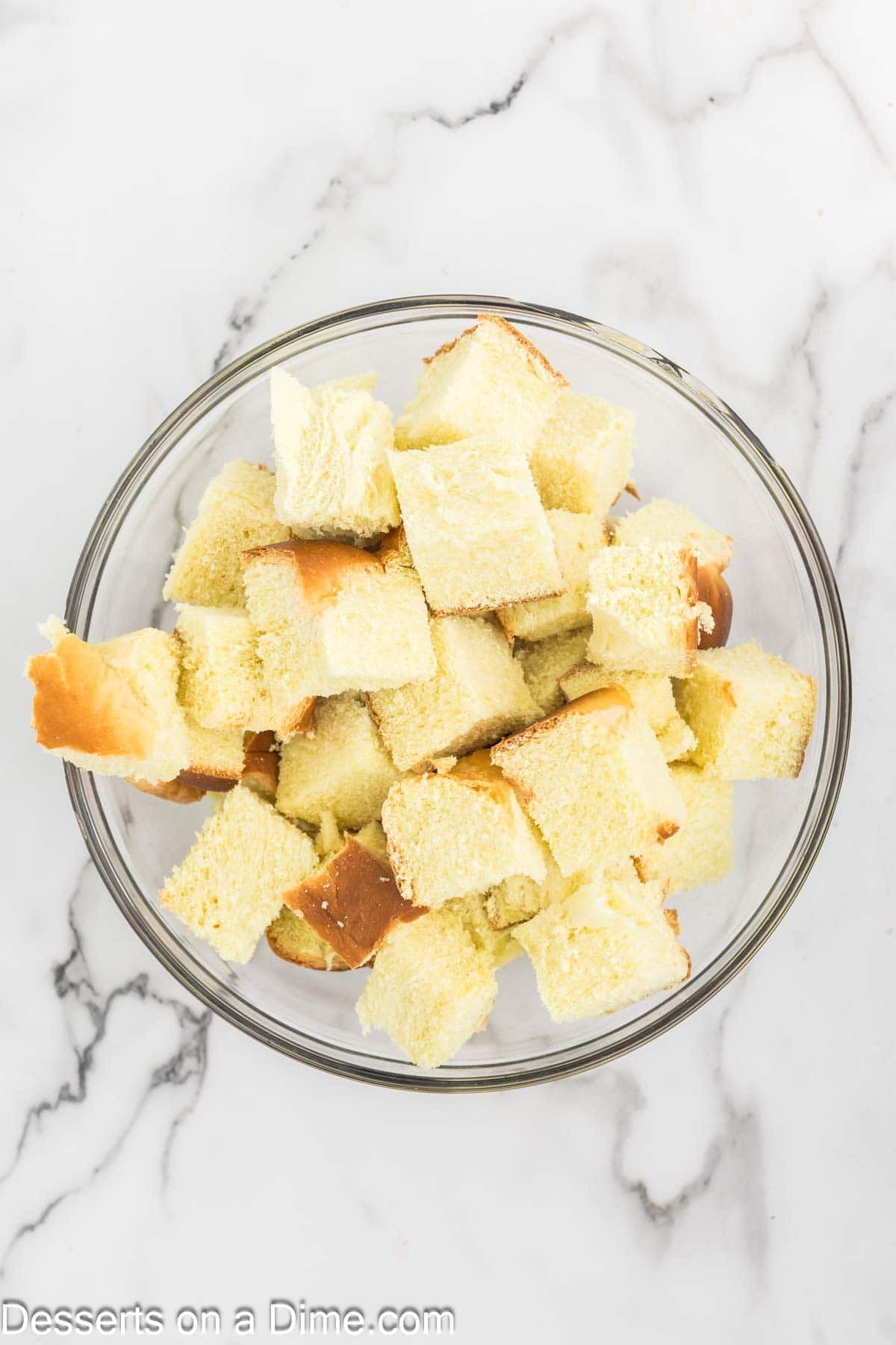 Mixing bowl of cut up bread. 