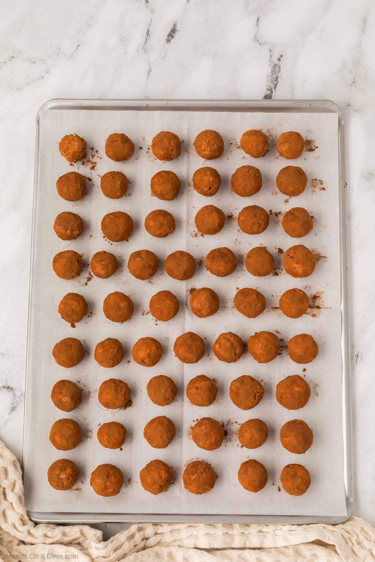 Irish Potato Balls on baking sheet coated in cinnamon. 