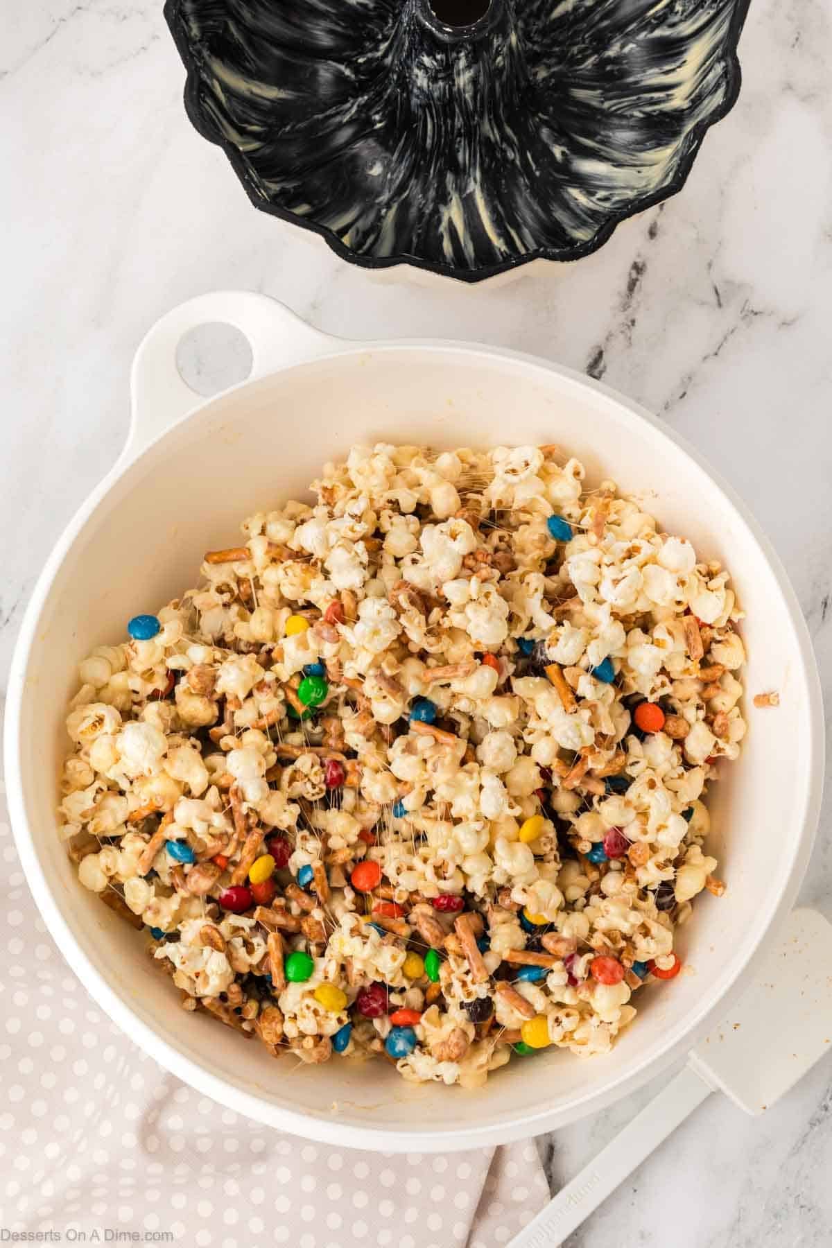 Melted marshmallow mixture poured over popcorn.