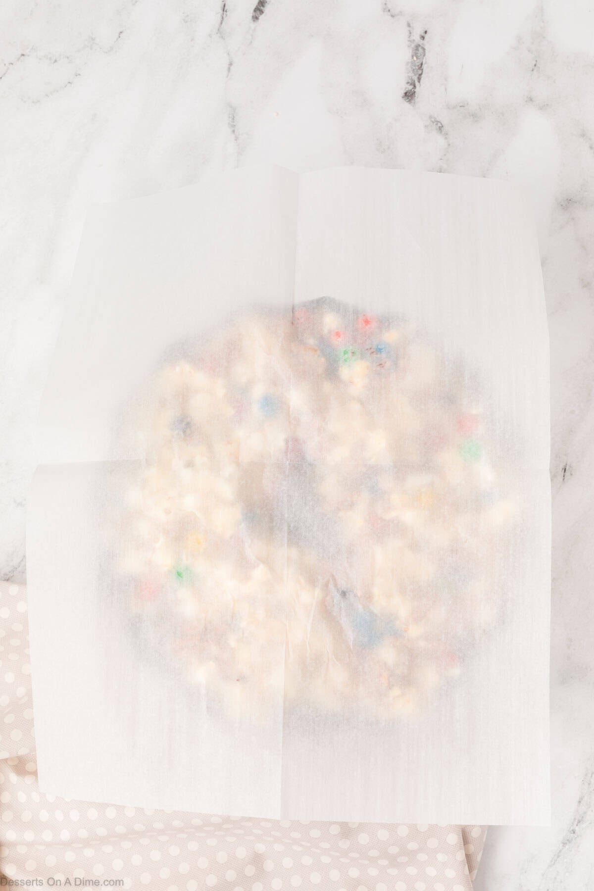 Parchment paper pressed on top of  cake mixture. 