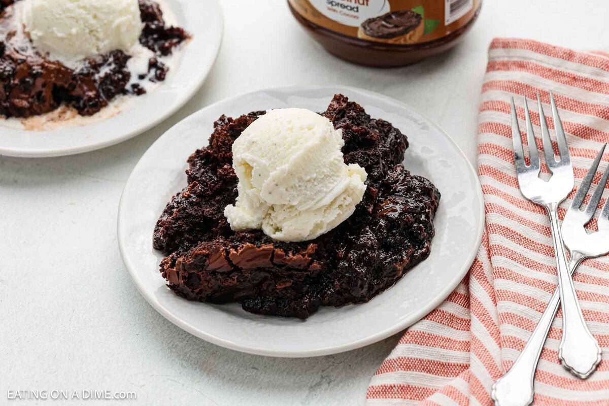 Crock Pot Chocolate Dump Cake topped with ice cream in bowls.