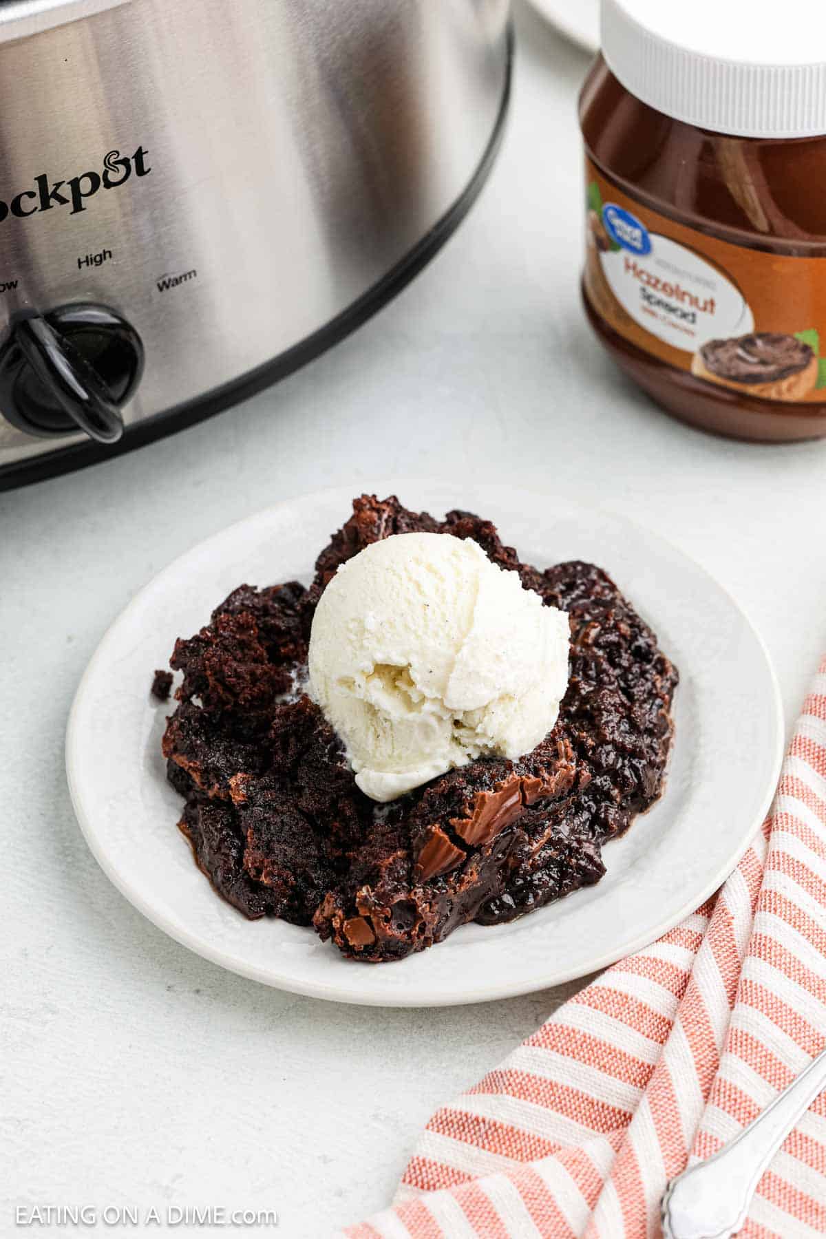 Serving of cake with ice cream on a white plate.