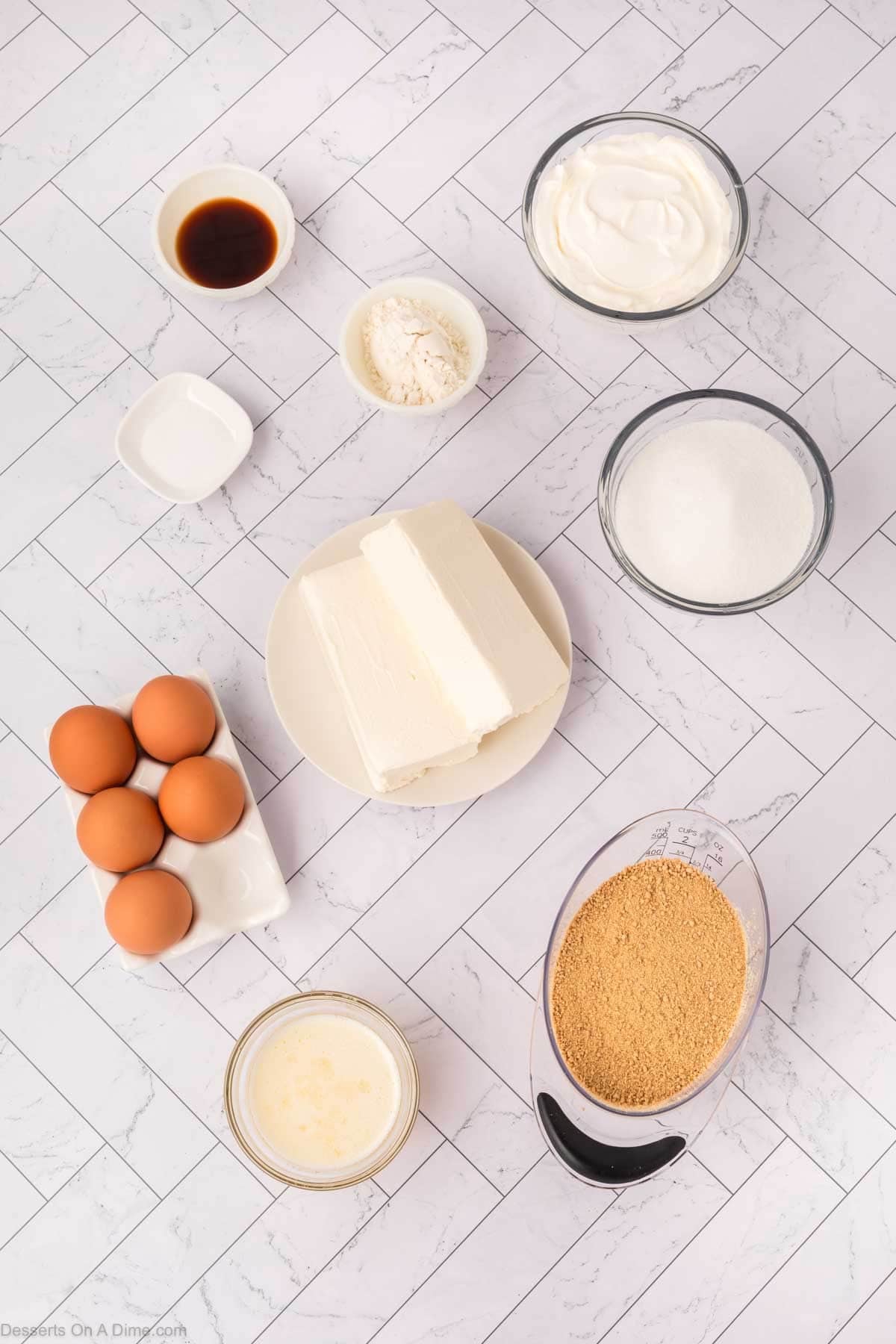 Ingredients for crock pot cheesecake - graham cracker crumbs, butter, cream cheese, sour cream, sugar, eggs, salt. 