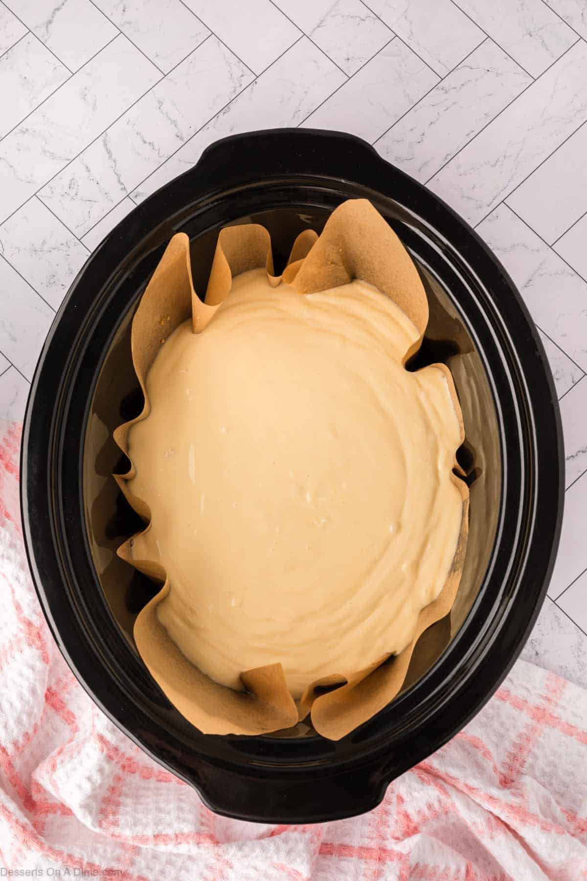 Cheesecake poured into crock pot on top of crust. 