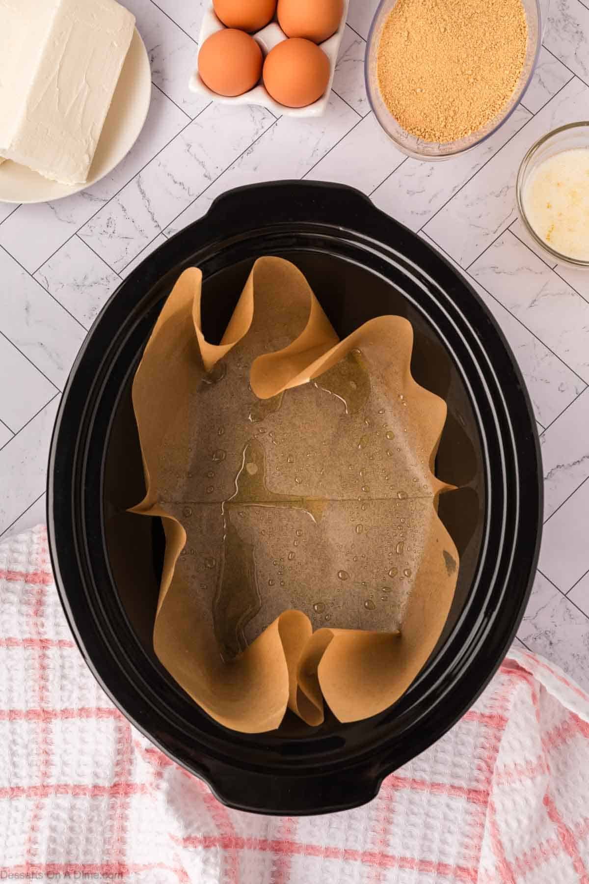 Crock pot lined with parchment paper. 