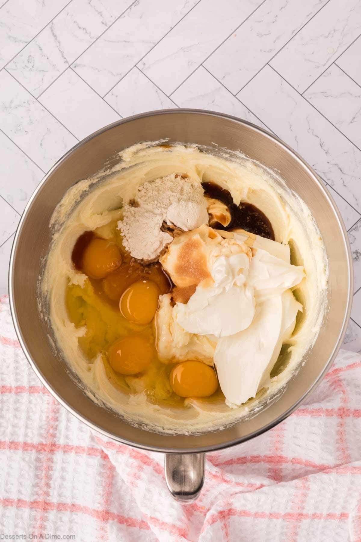 Eggs, sour cream and vanilla added to mixing bowl. 