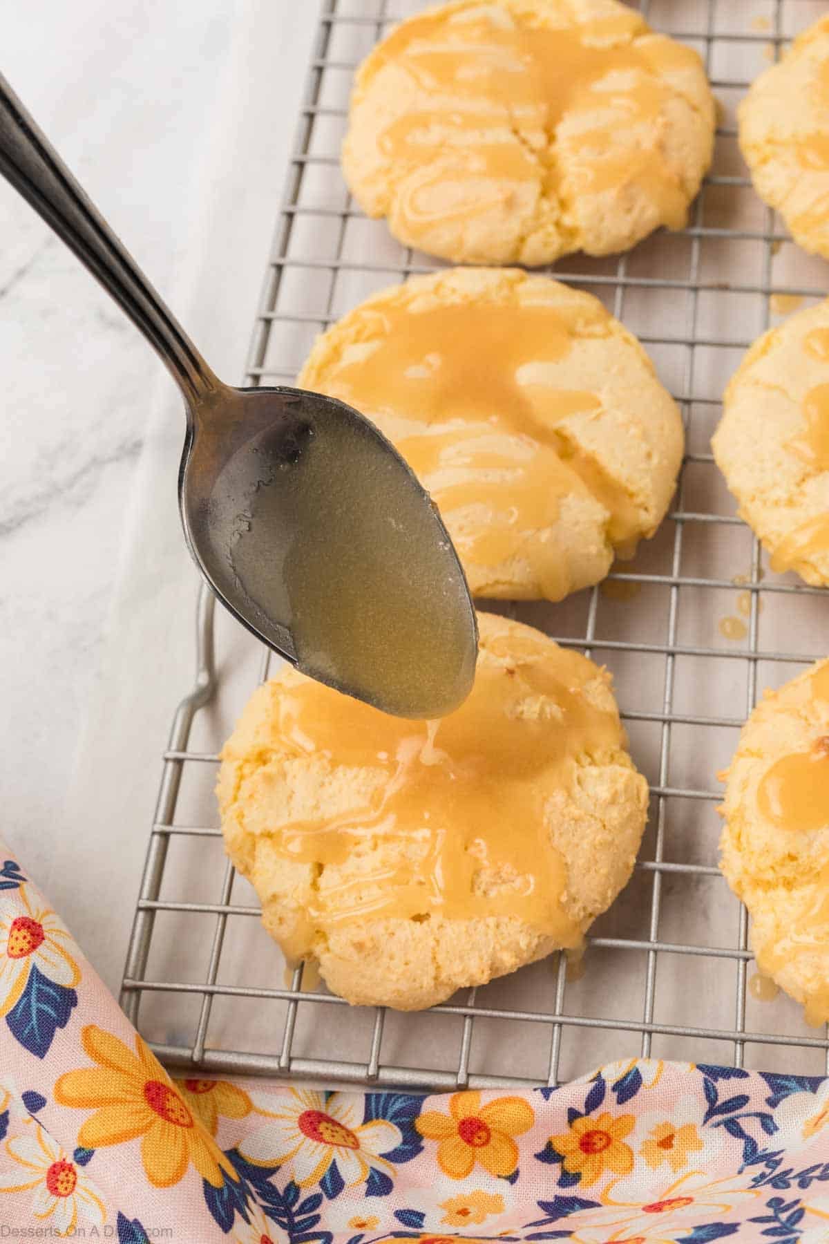 drizzling the glaze over the baked cookies