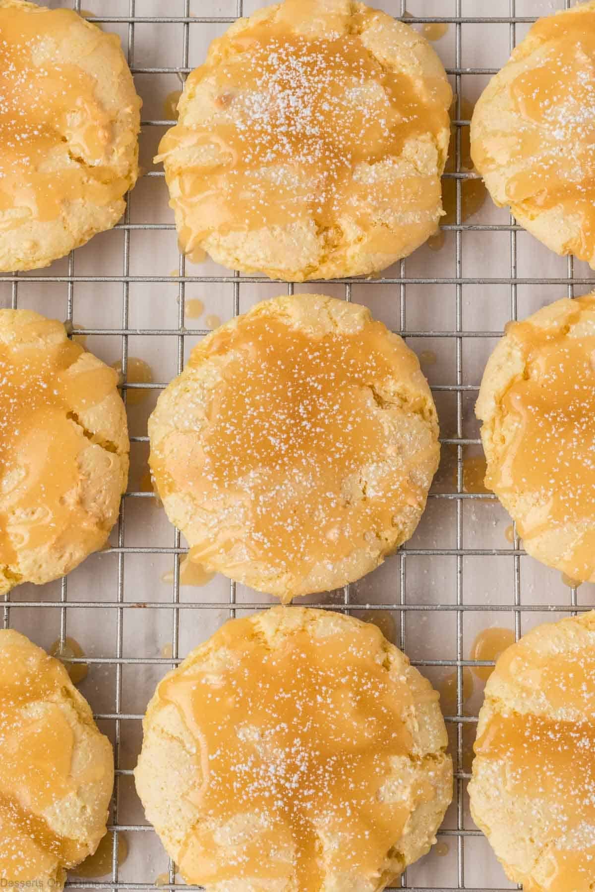 Butter Cake Mix Cookies on a wire rack topped with butter glaze and powdered sugar