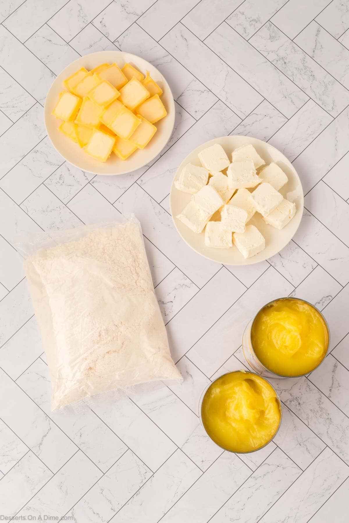 Ingredients for Lemon Cream Cheese Dump Cake - lemon pie filling, yellow cake mix, cream cheese, butter. 