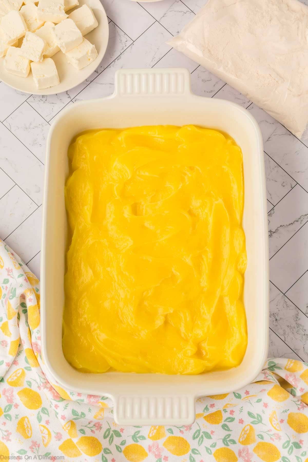 Lemon pie filling spread into the bottom of the pan. 