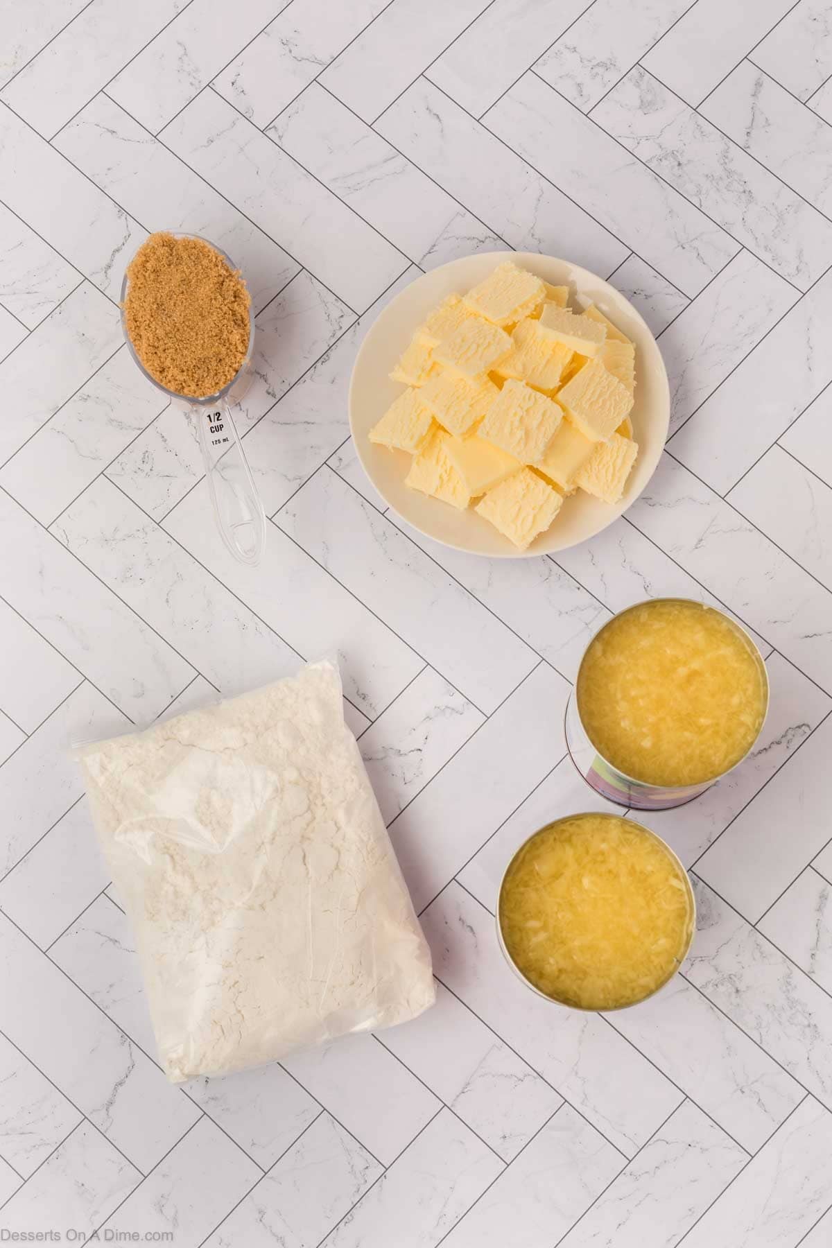 Ingredients for recipe - crushed pineapple, brown sugar, yellow cake mix, butter. 