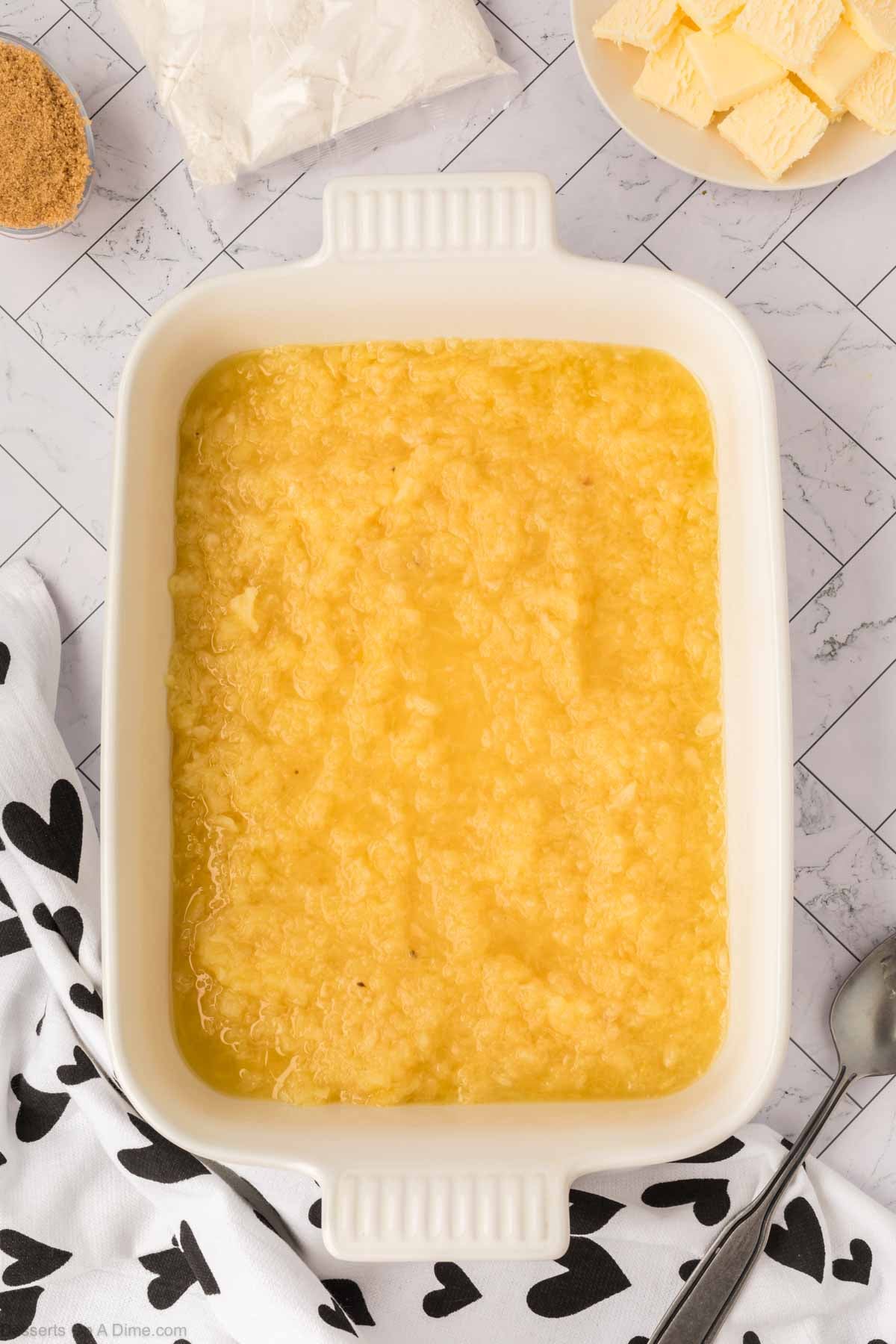 Crushed pineapple in baking dish. 