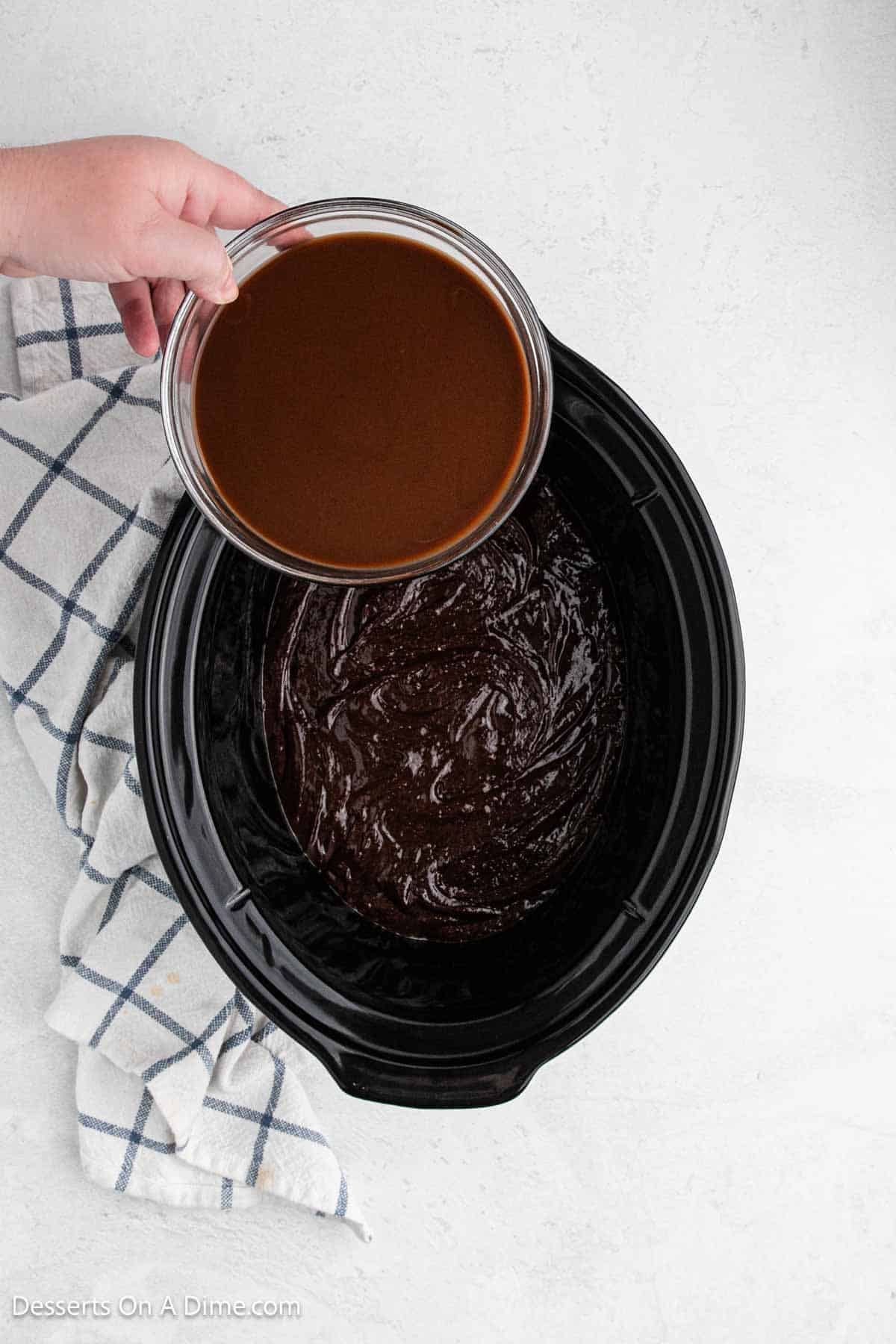 Chocolate sauce being poured over batter. 