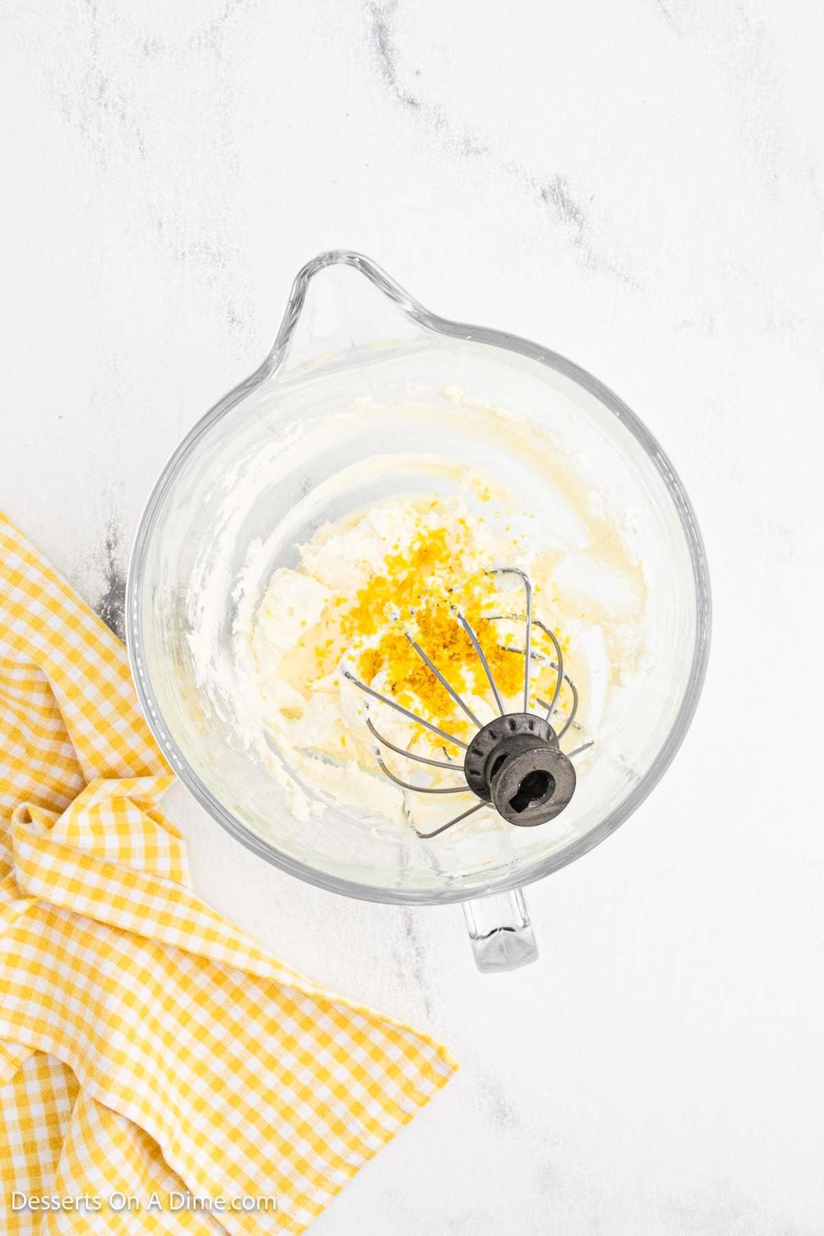 Lemon zest added into mixing bowl. 