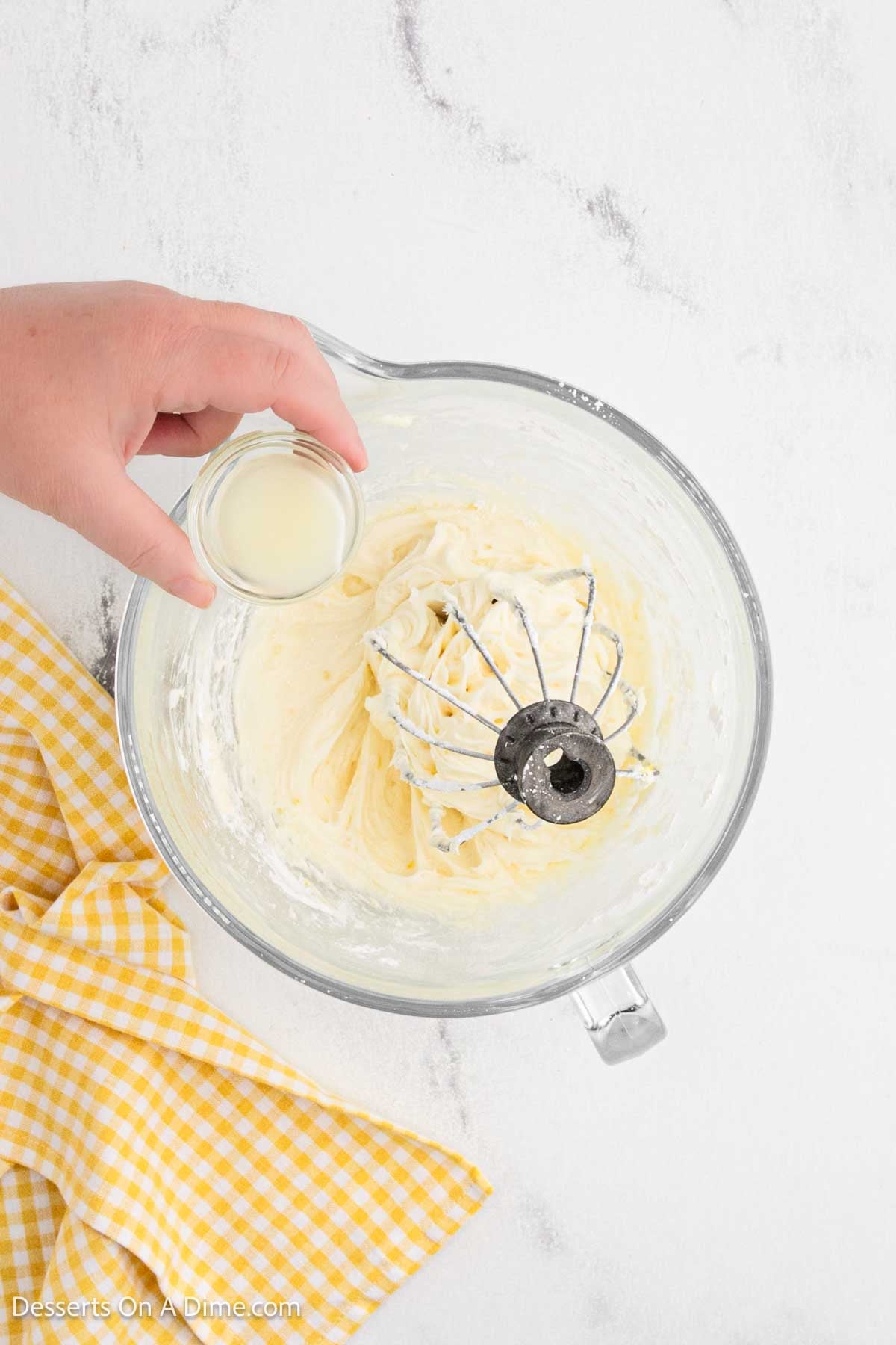 Lemon juice being poured into mixing bowl. 