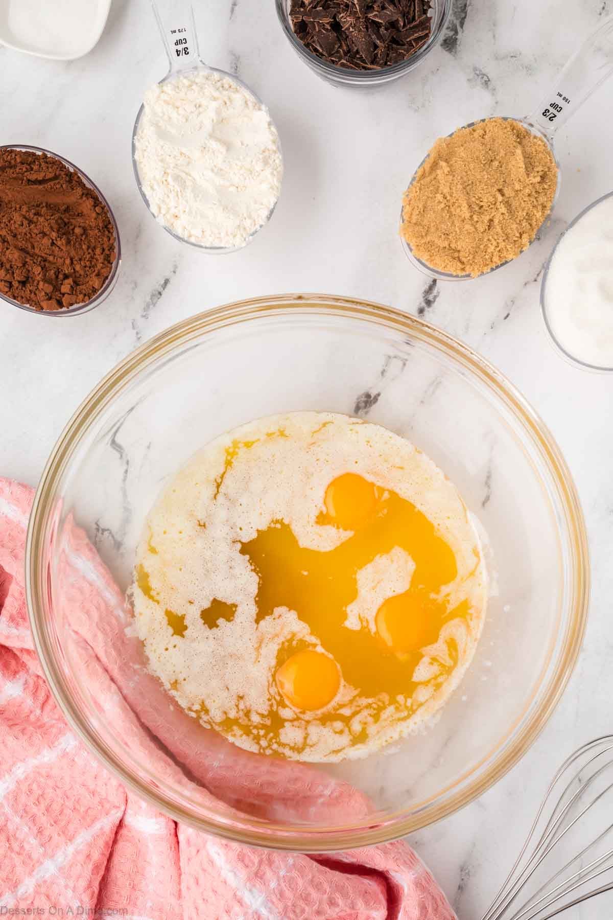 Melted butter, eggs and vanilla in a mixing bowl. 