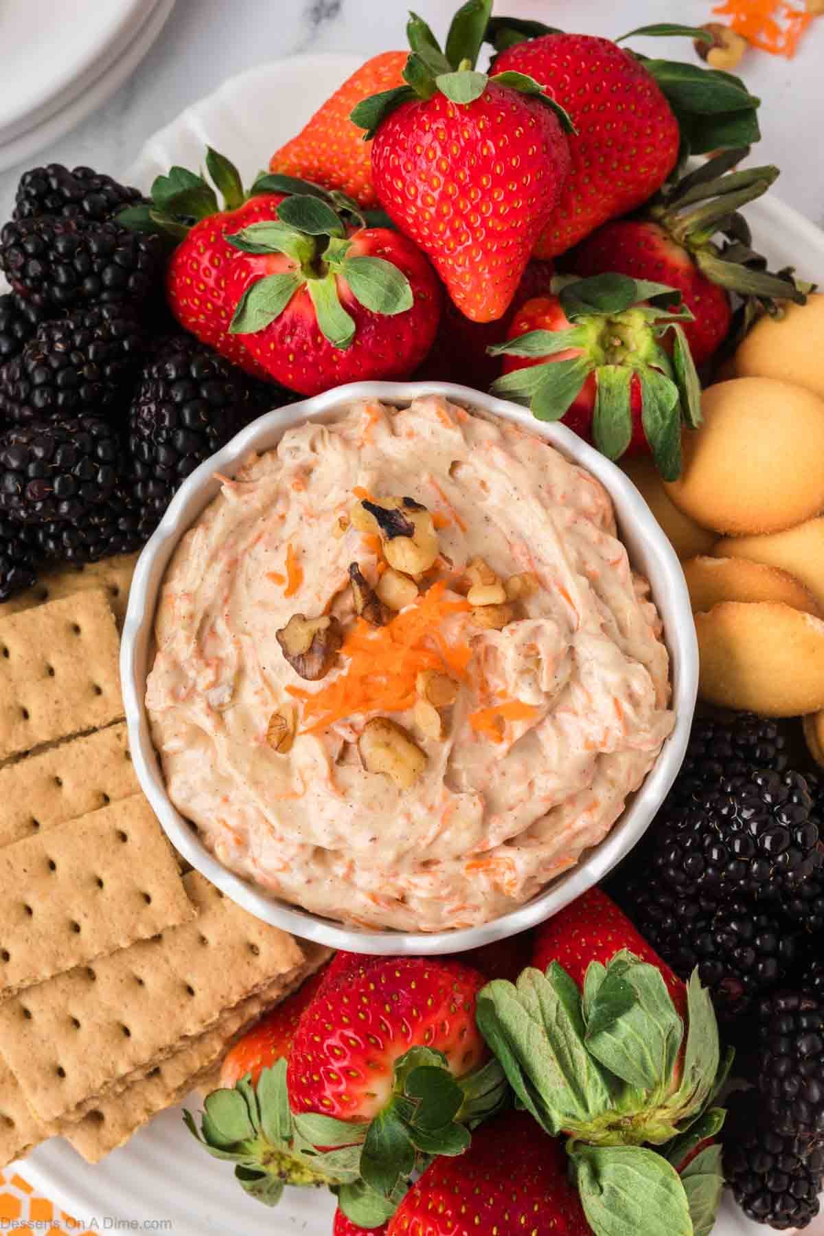 Carrot Cake Dip in a bowl surrounded by dippers. 