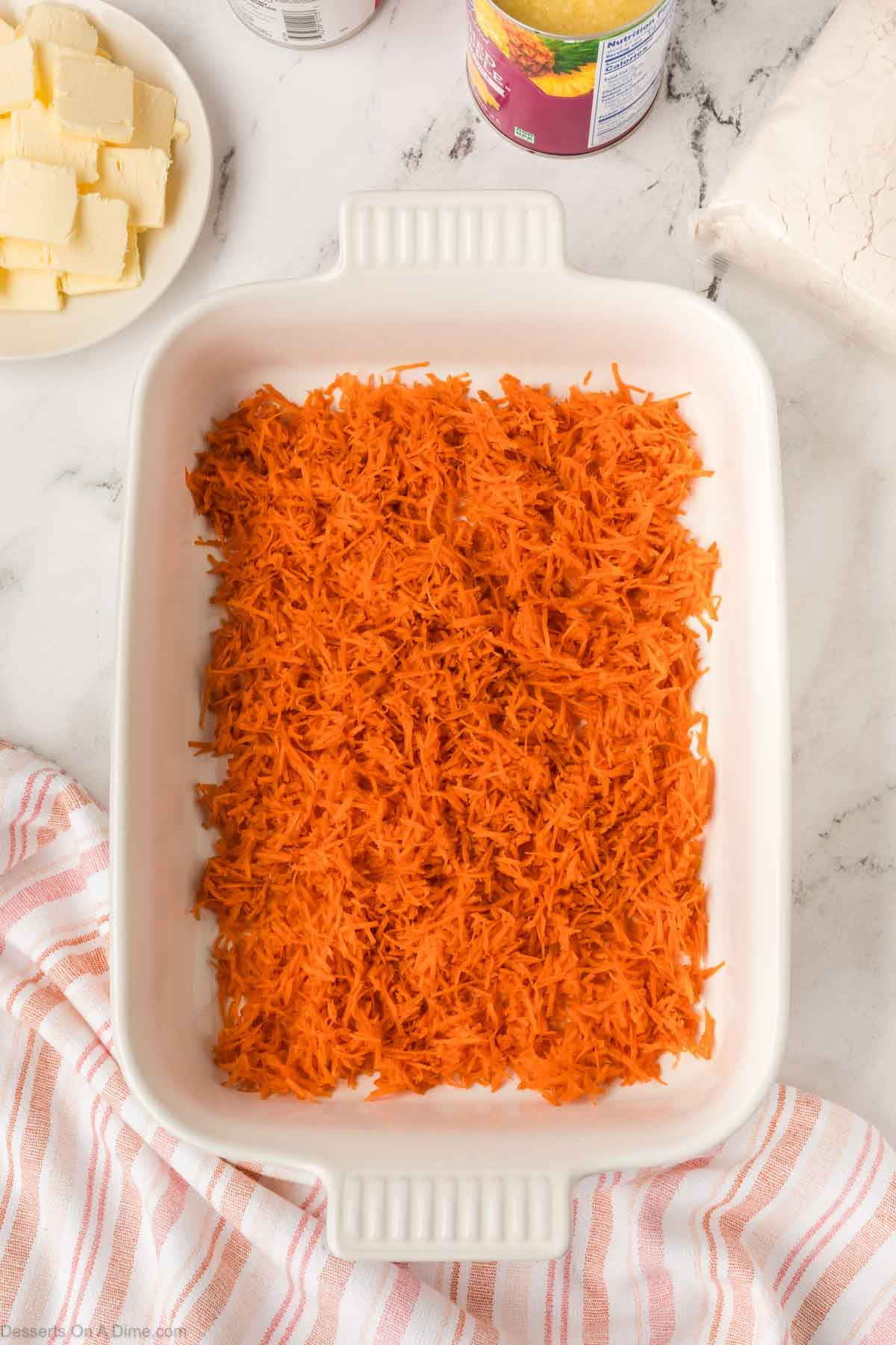 Grated carrots in baking dish. 