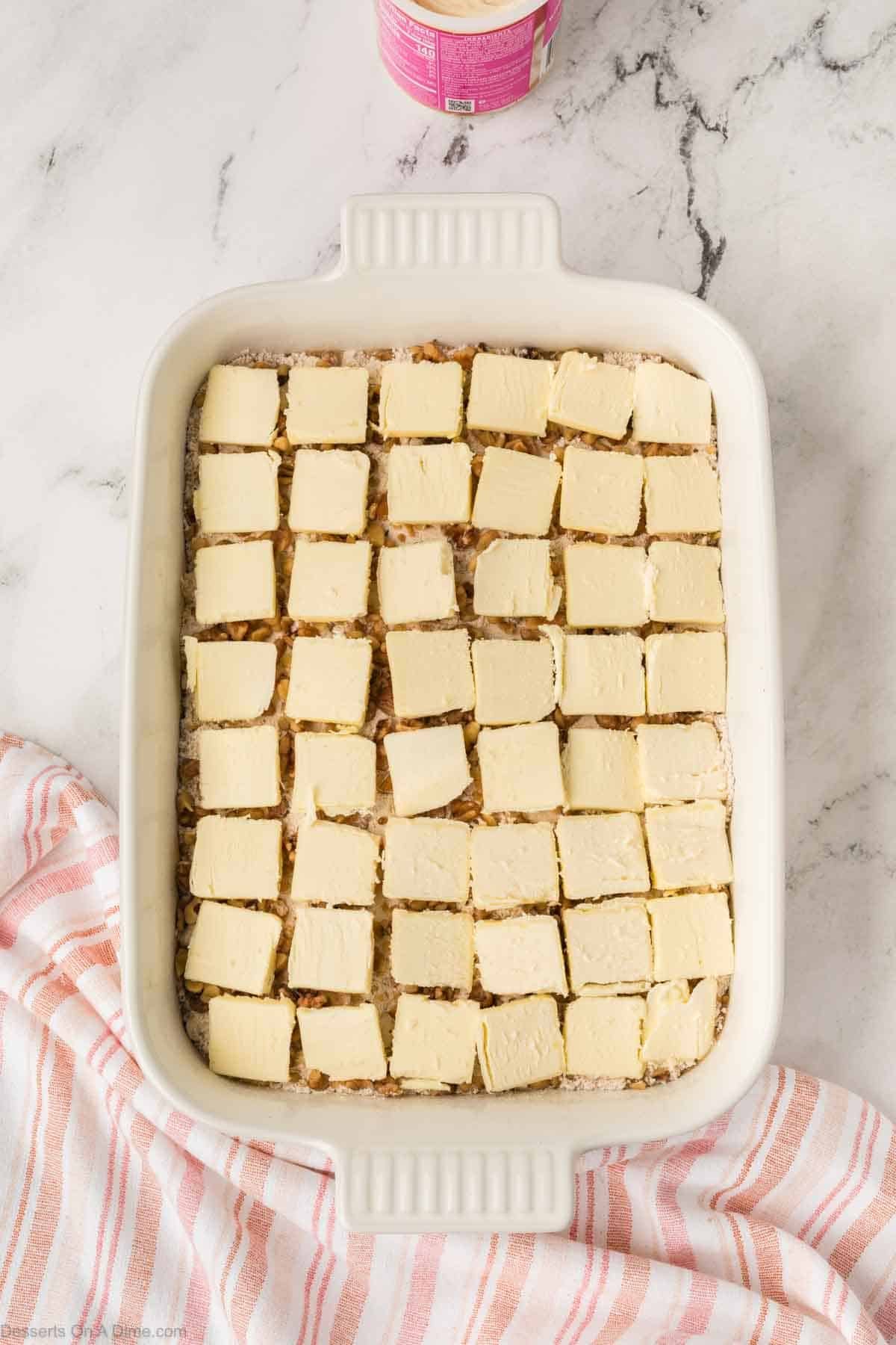 Sliced butter arranged on top. 