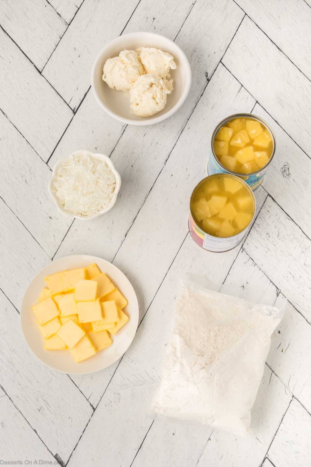 Ingredients for recipe - yellow cake mix, pineapple chunks, butter, shredded coconut, ice cream. 