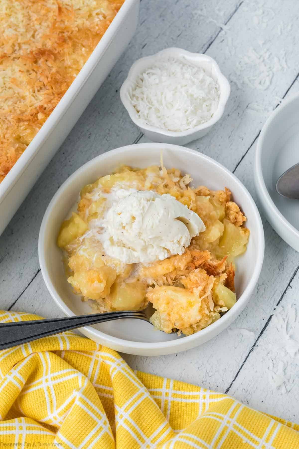 Cake topped with ice cream in a white bowl. 