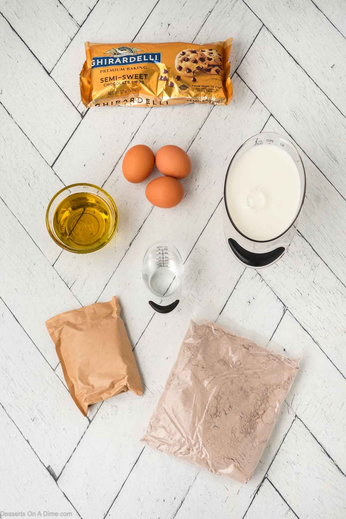 Ingredients for recipe - pudding mix, milk, chocolate cake mix, eggs, vegetable oil, chocolate chips. 