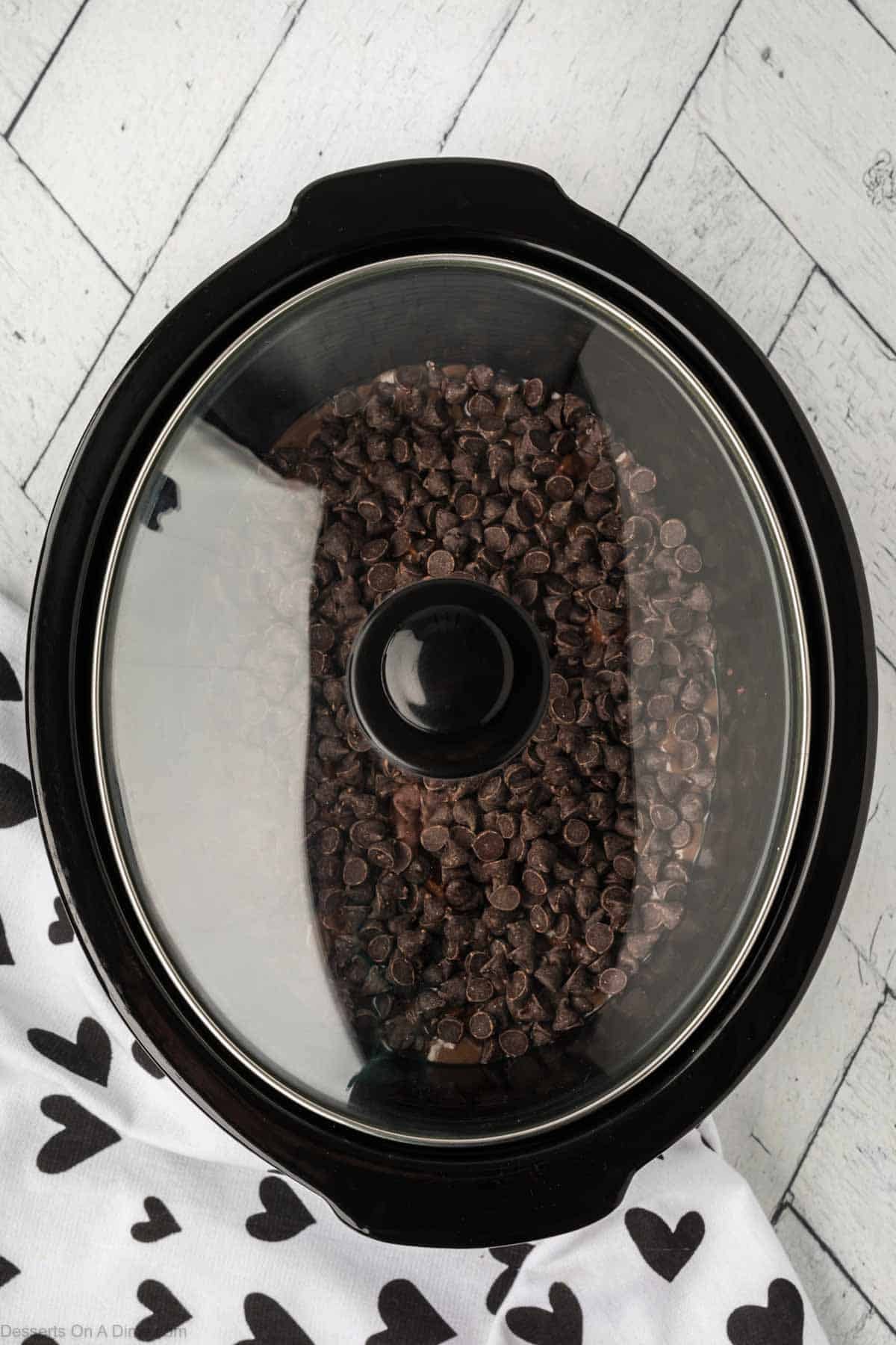 Lid placed on slow cooker. 