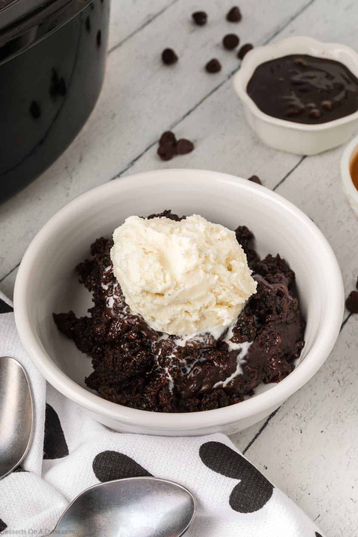Cake topped with ice cream in a bowl. 