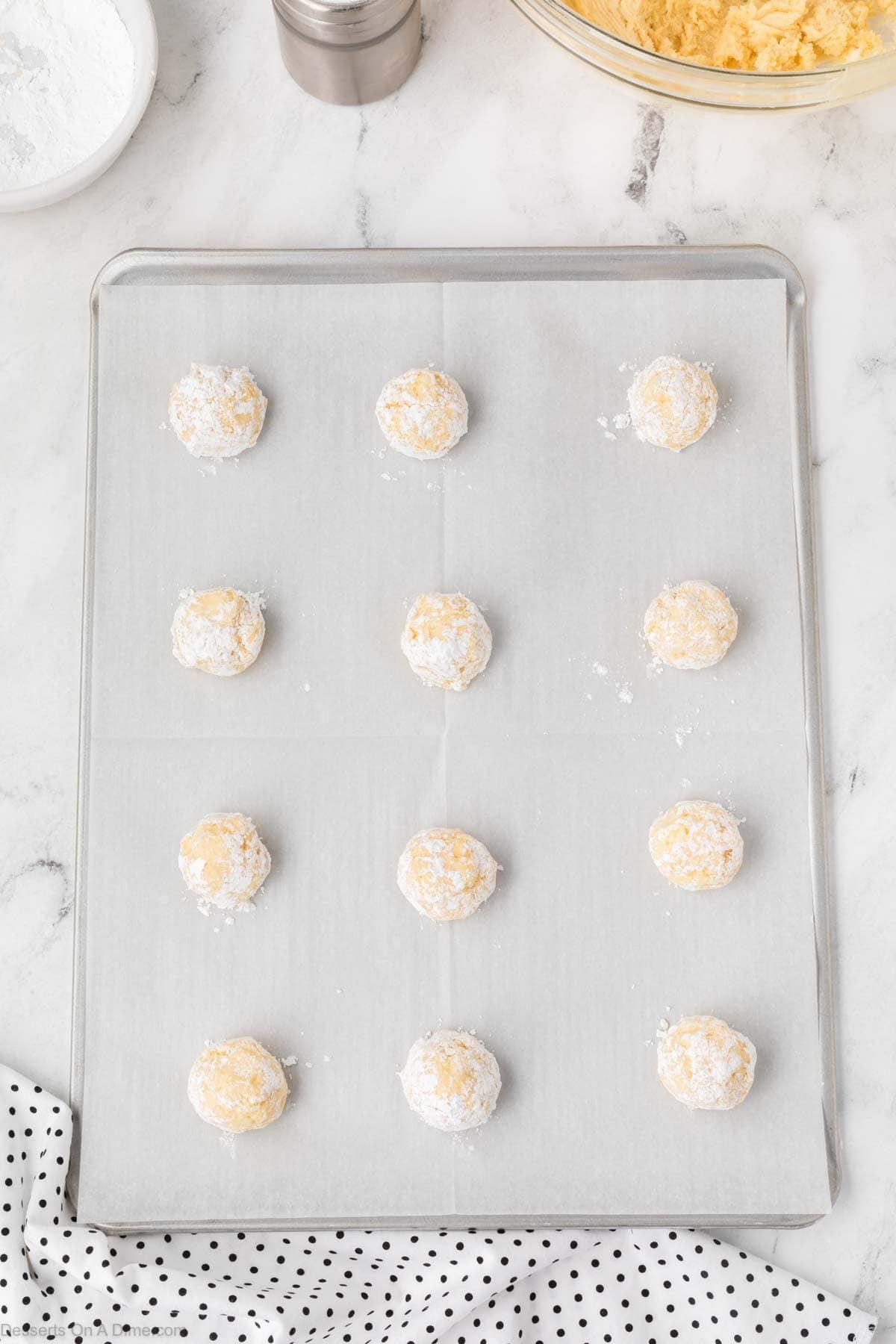 Cookie dough balls on baking sheet. 