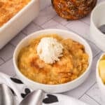 Pineapple Dump Cake in a bowl with ice cream.