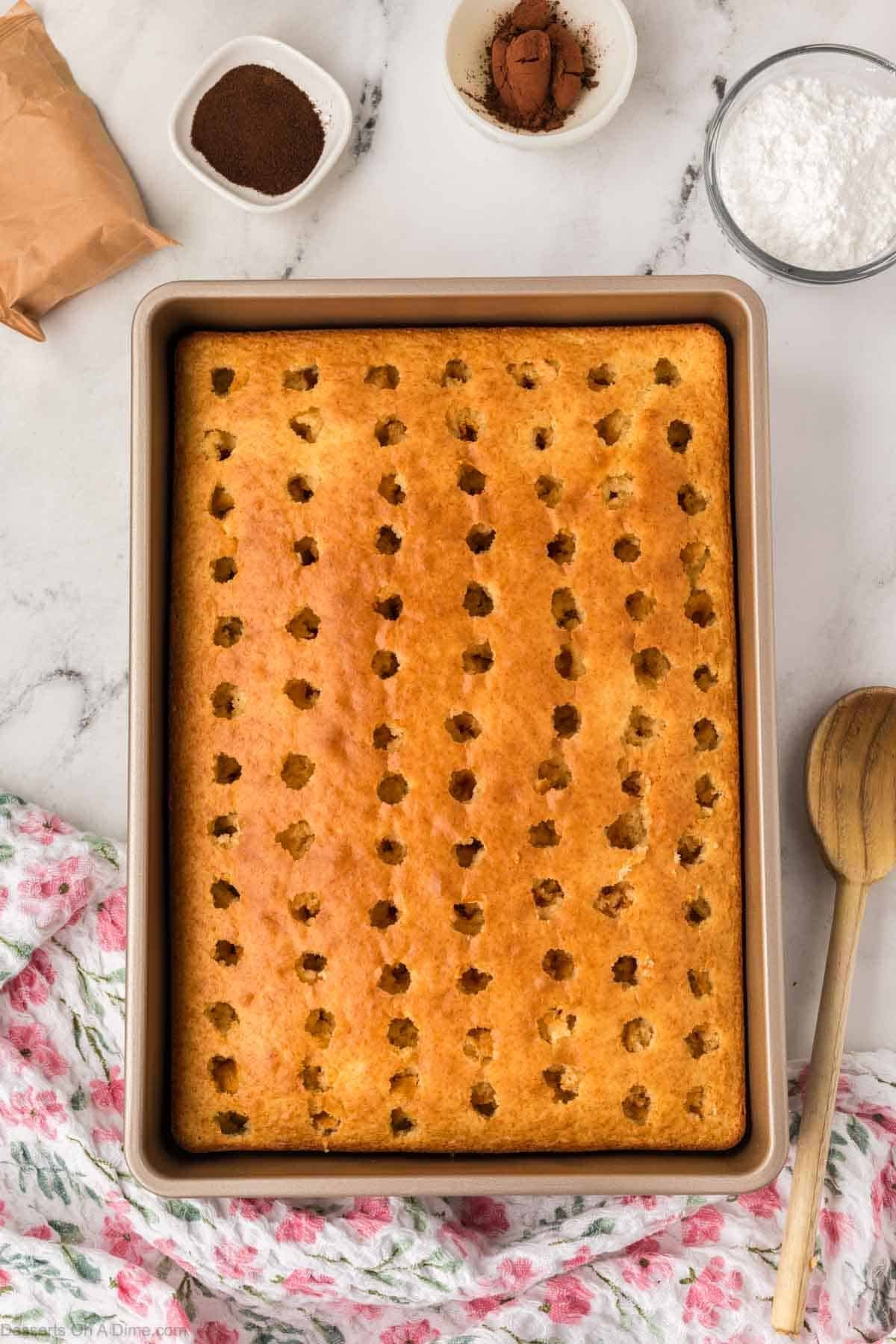 Holes poked in cake.