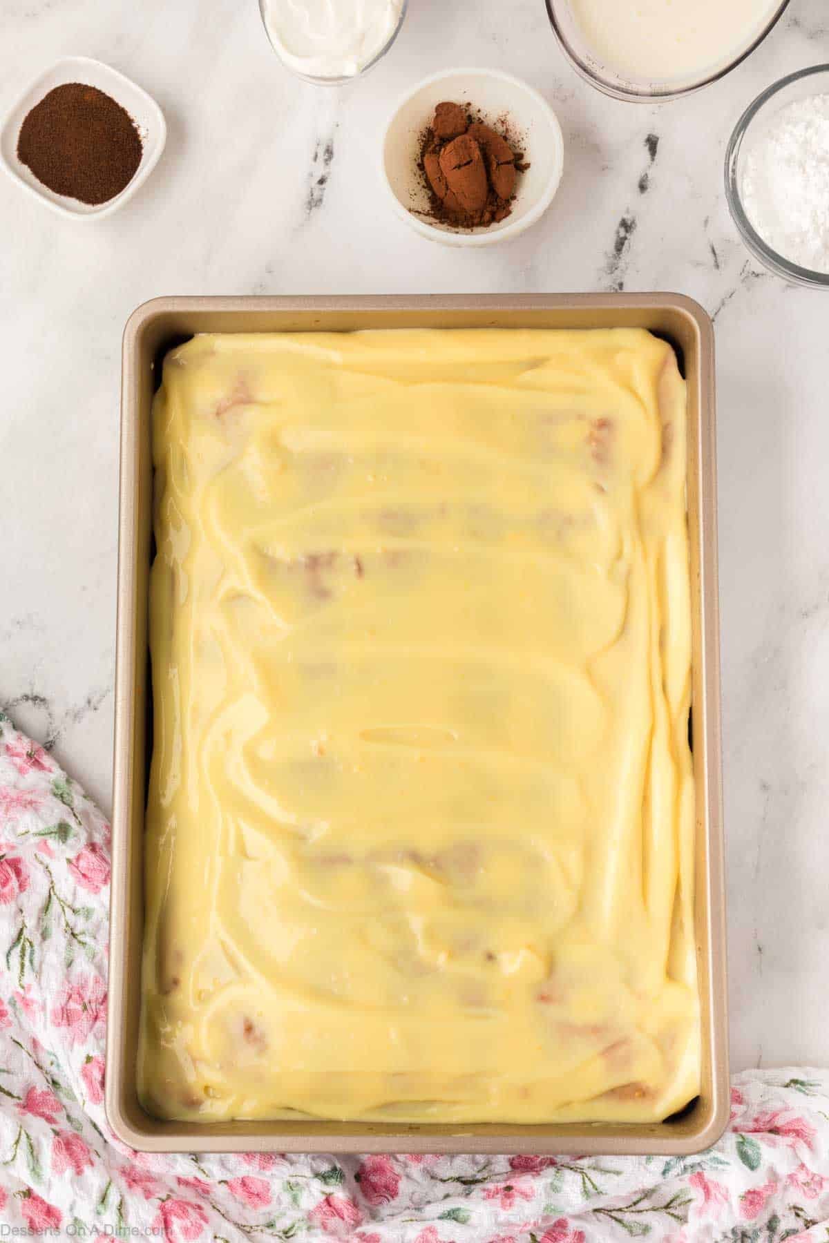 Pudding mixture spread on cake.