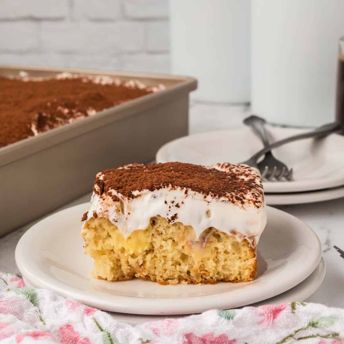 Slice of Tiramisu Poke Cake on a plate.