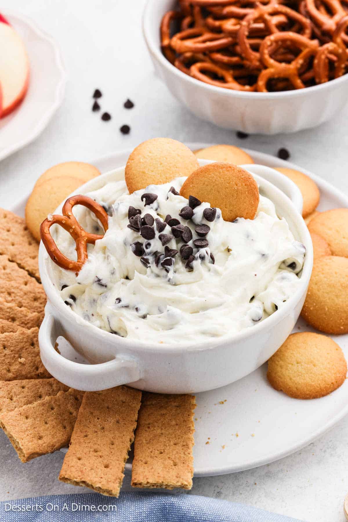 Chocolate Chip Cheesecake Dip in a bowl with dippers around it. 
