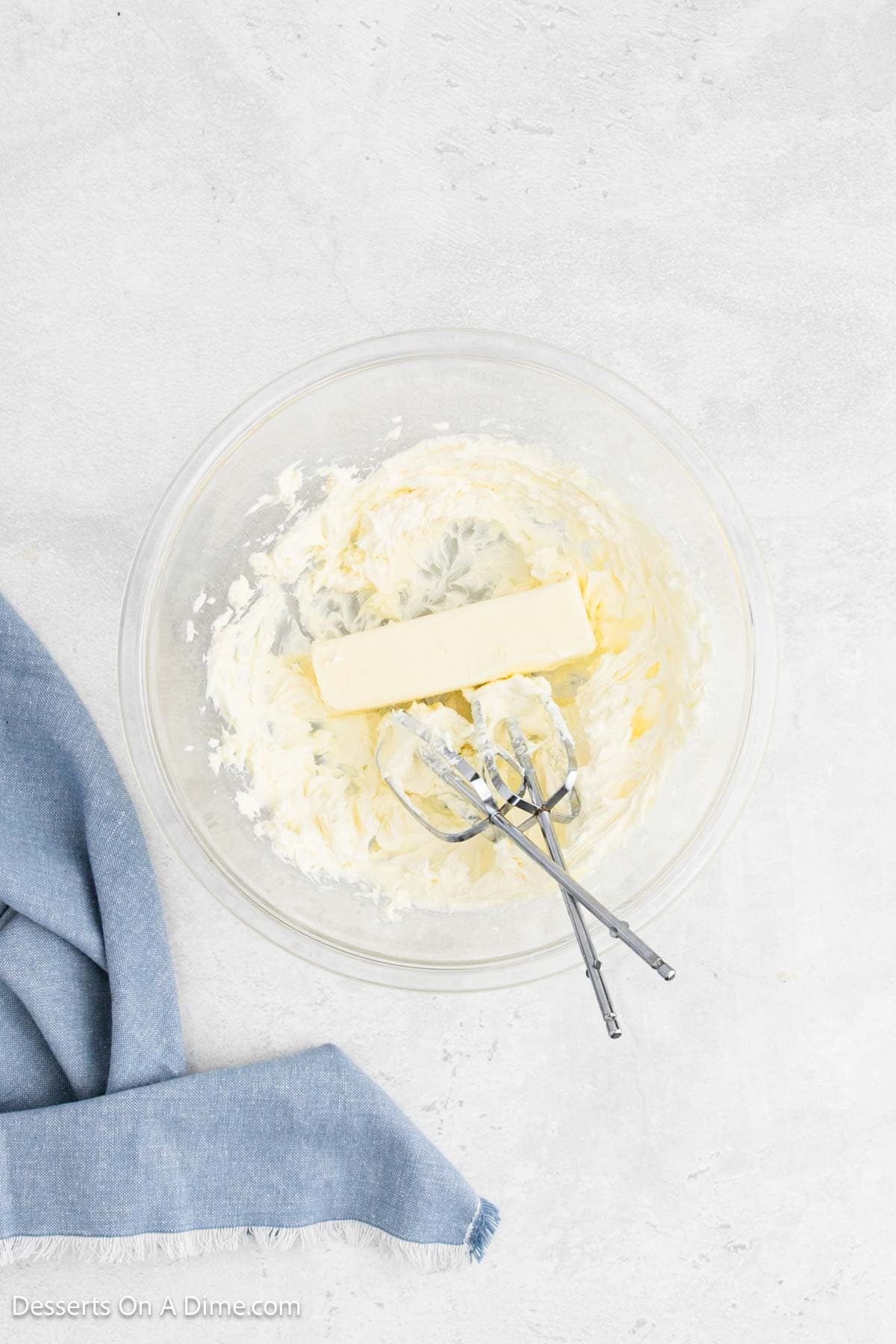 Butter combined with cream cheese in a mixing bowl. 