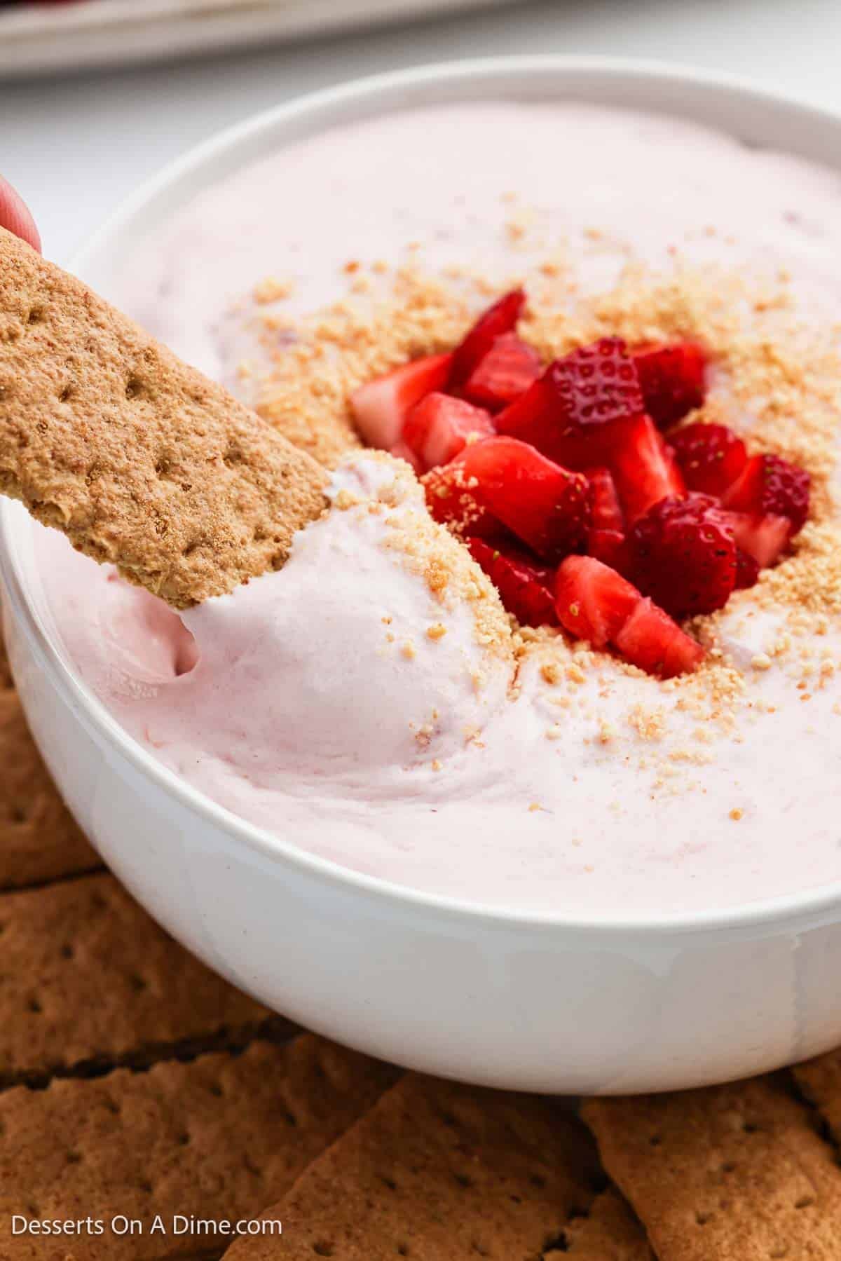 Strawberry Cheesecake Dip with graham crackers in a bowl. 