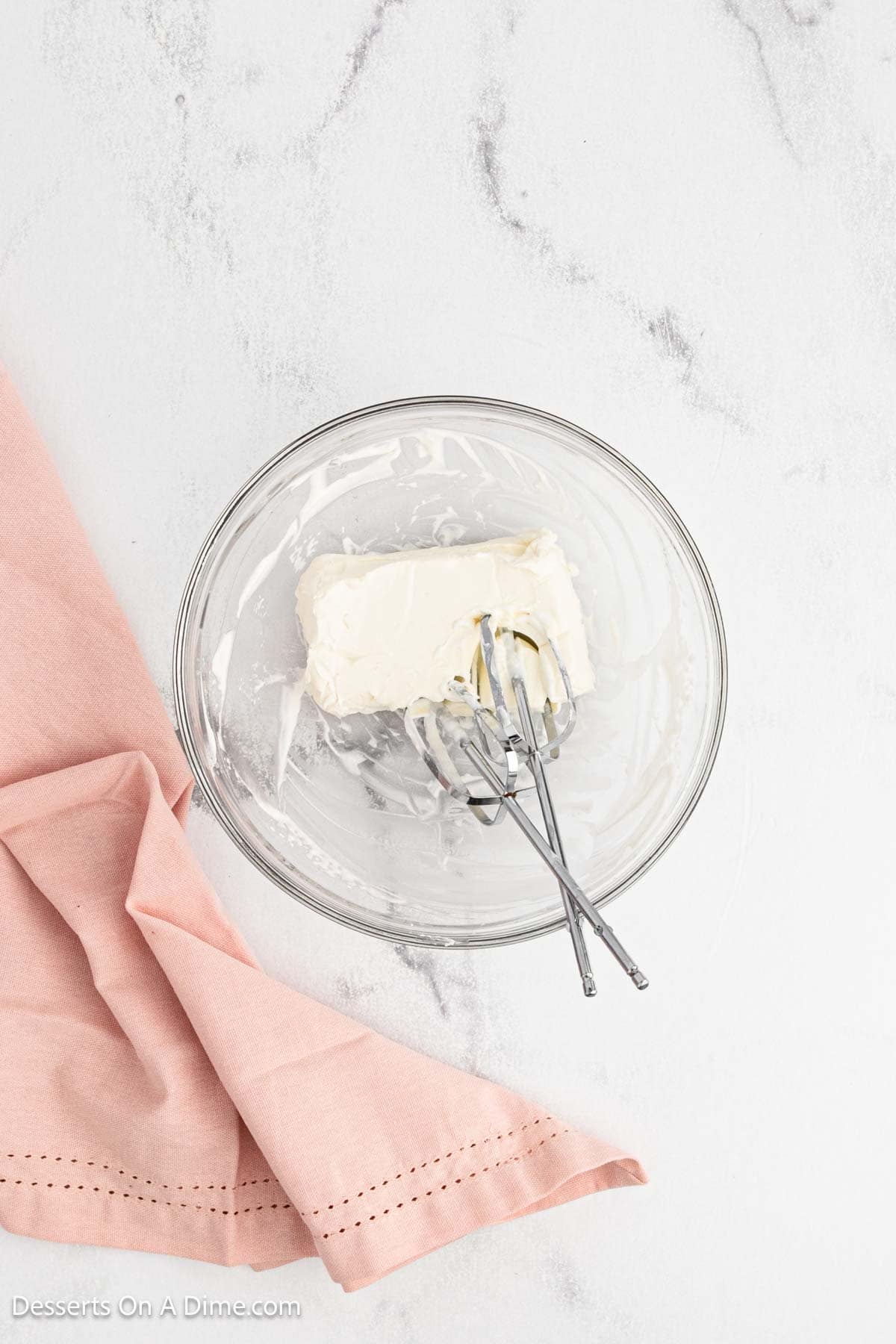 Cream cheese ready to be beat in a bowl. 