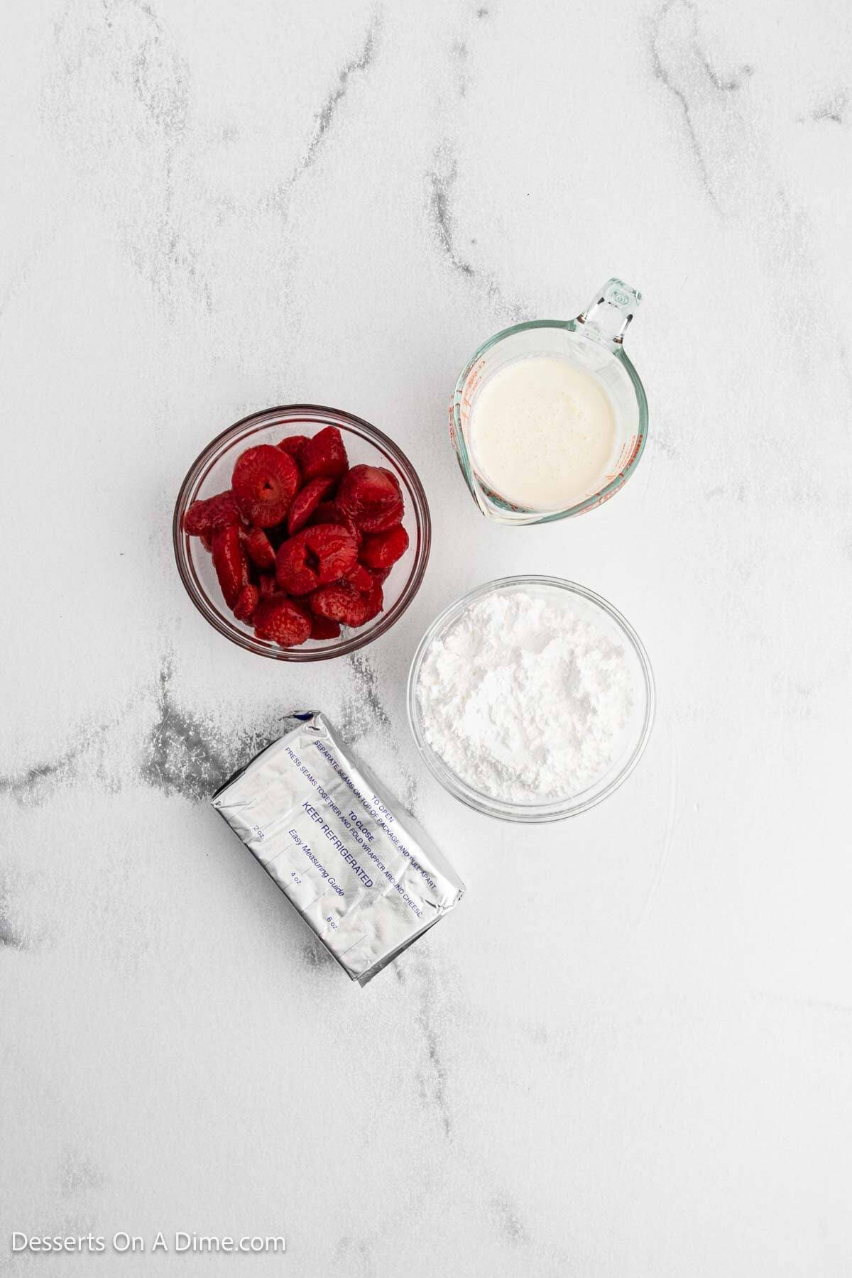 Ingredients for recipe: frozen sliced strawberries, heavy whipping cream, cream cheese, powdered sugar. 