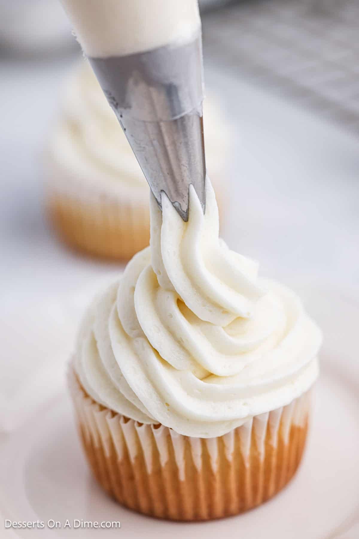 Whipped Vanila Frosting piped on a cupcake. 