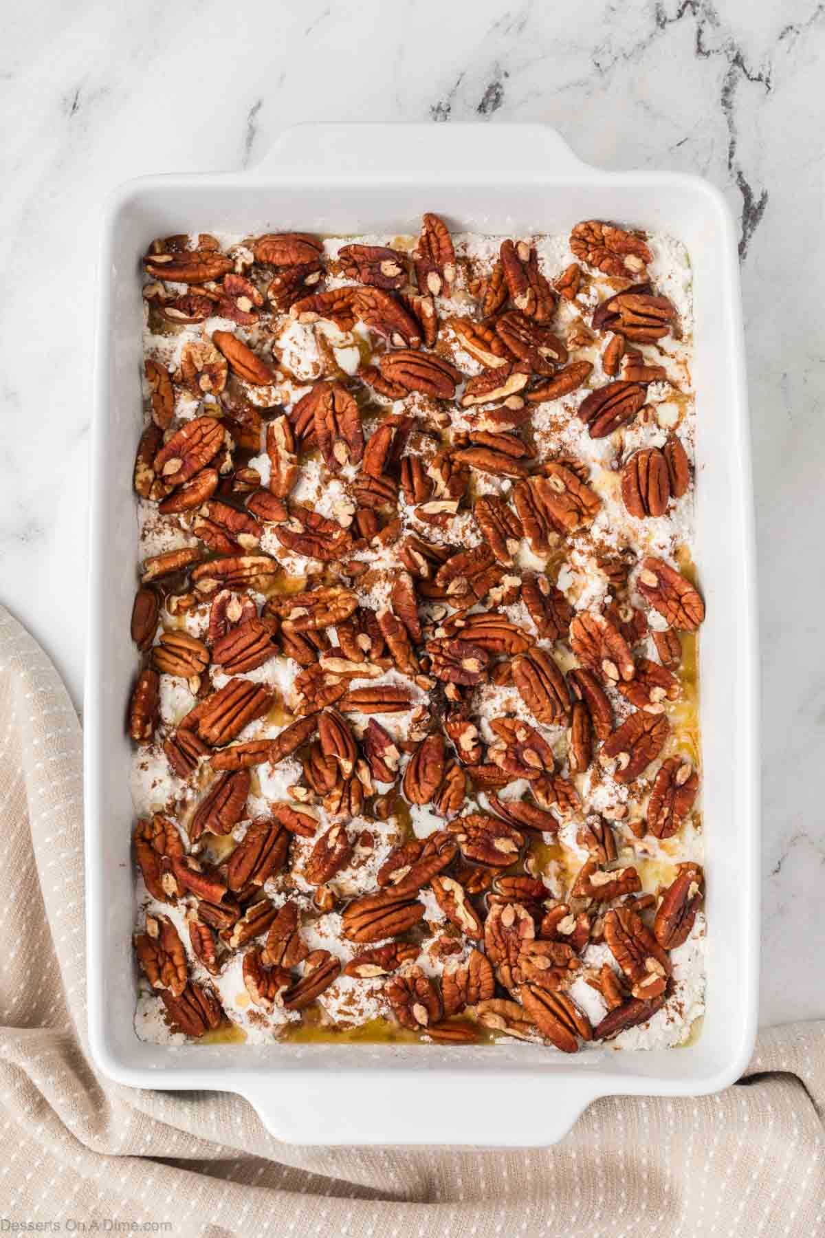 Pecans sprinkled on top of cake mix. 
