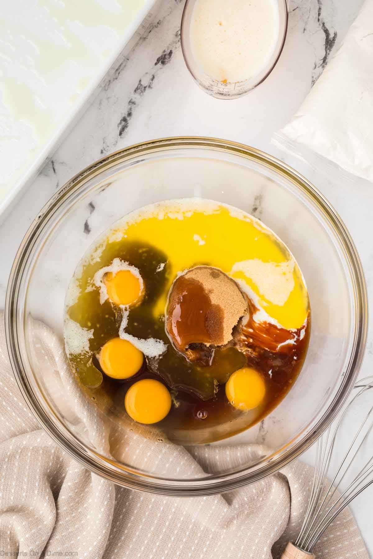 Eggs, corn syrup, sugar and heavy whipping cream in a bowl. 