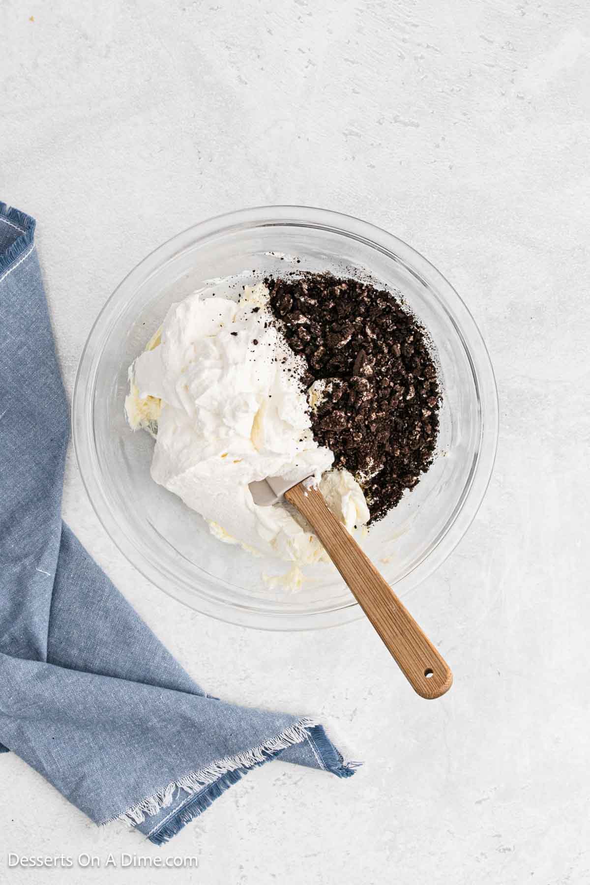 Whipped cream mixture folded into cookies in a bowl.