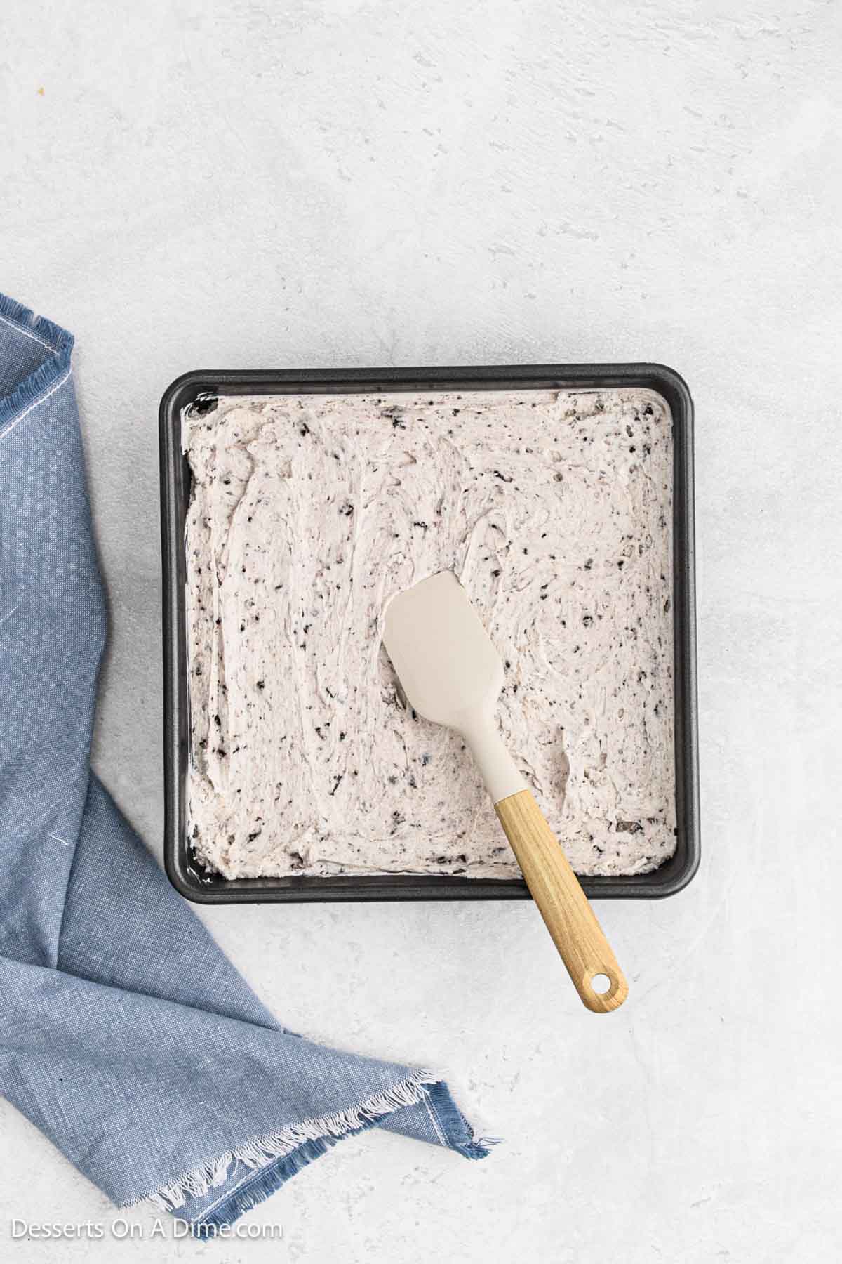 Cookie and cream mixture spread into baking dish.