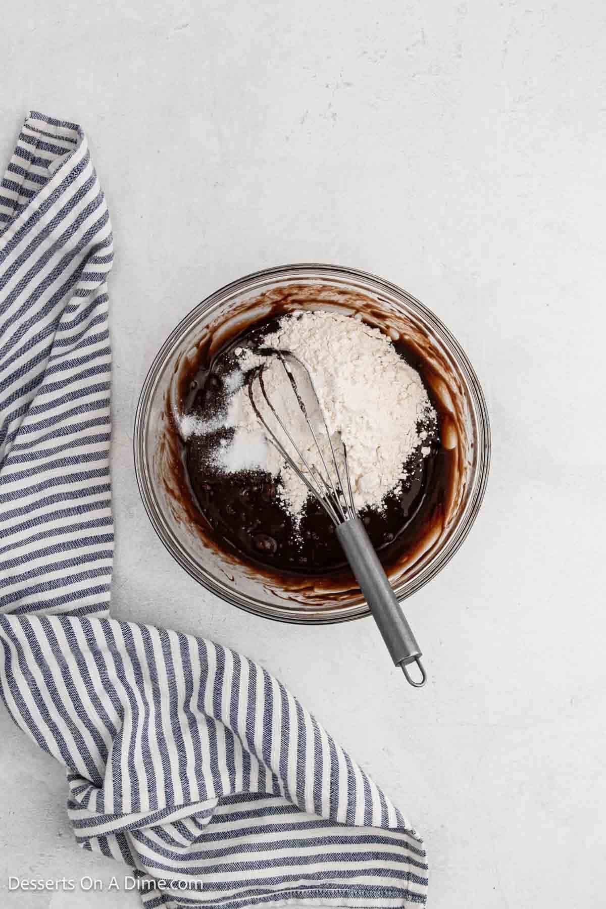 Flour added to nutella mixture in a bowl.