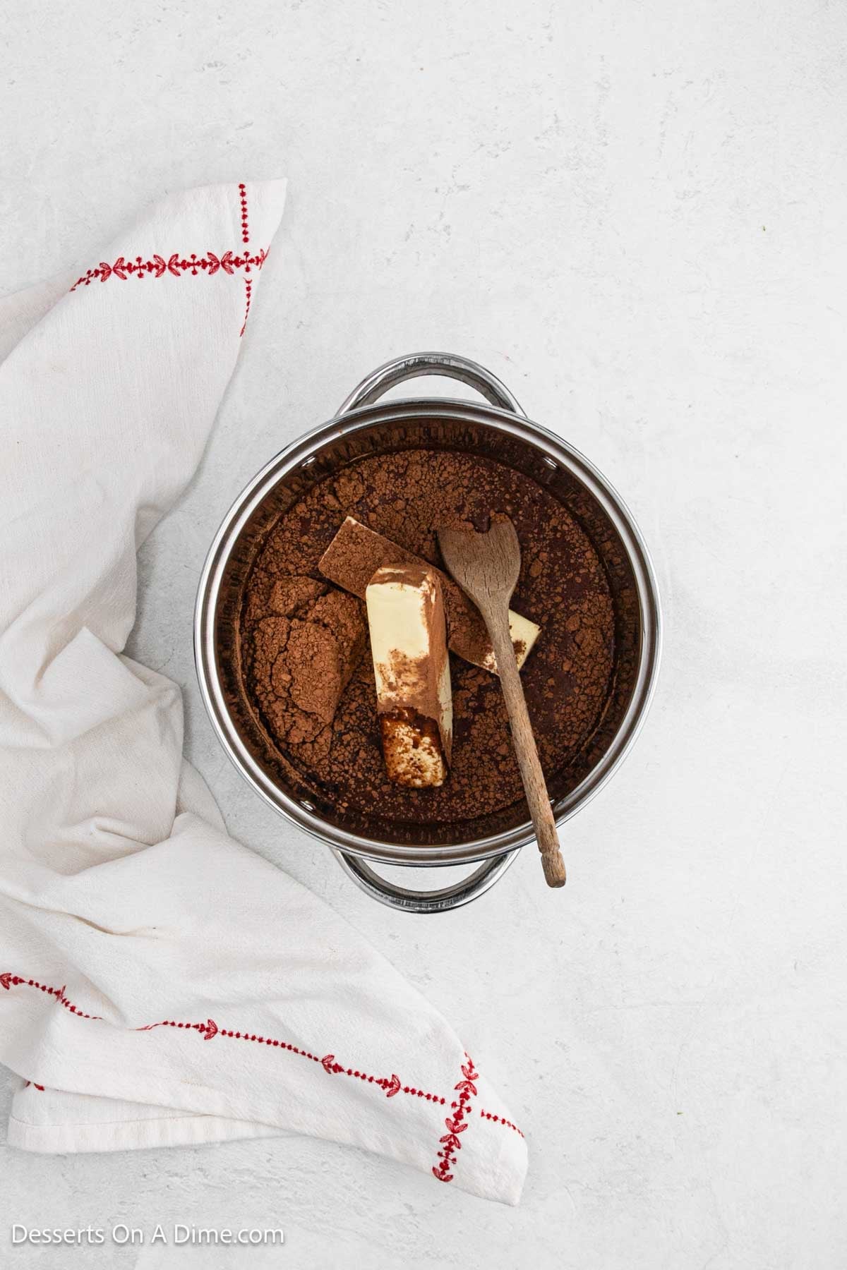 Saucepan with cocoa powder, butter and cola. 