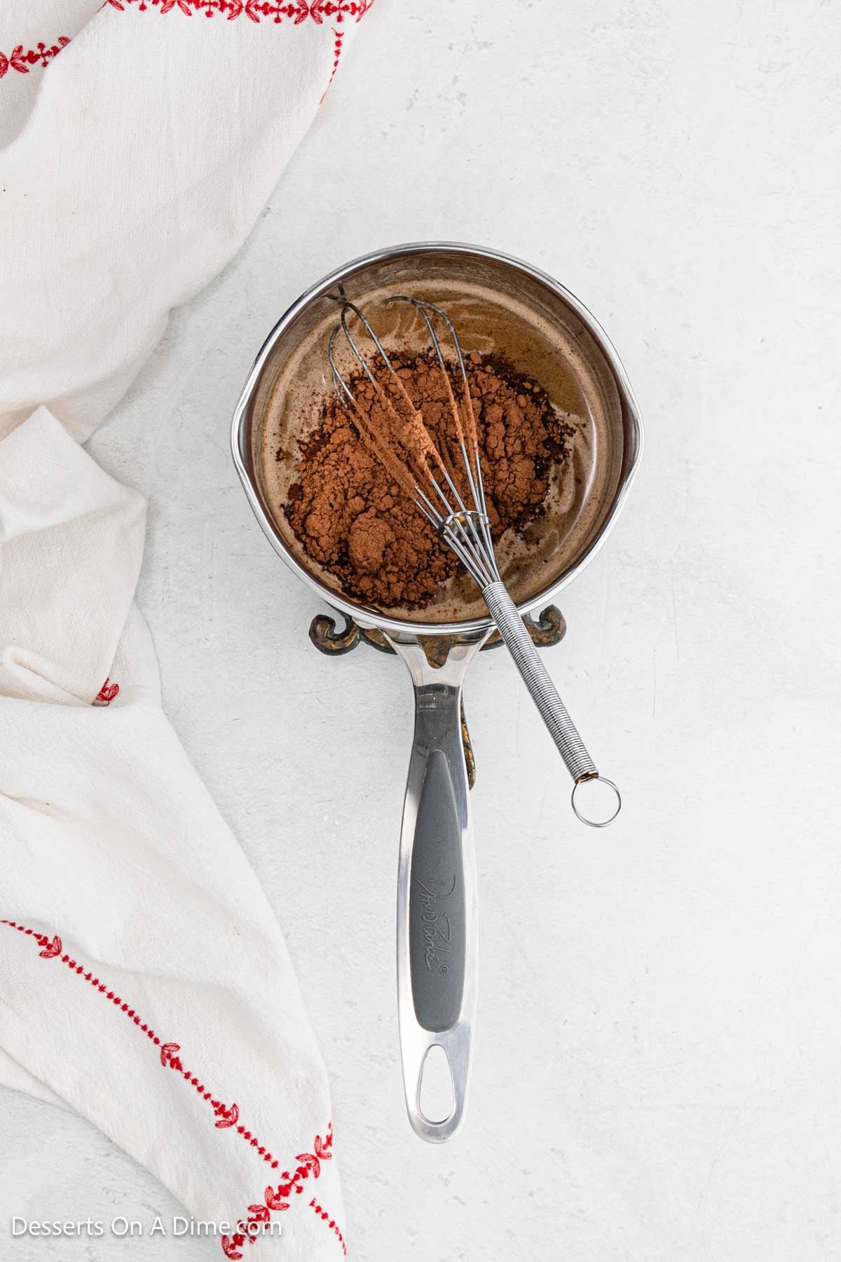 Cocoa mixture added to mixture in pan.