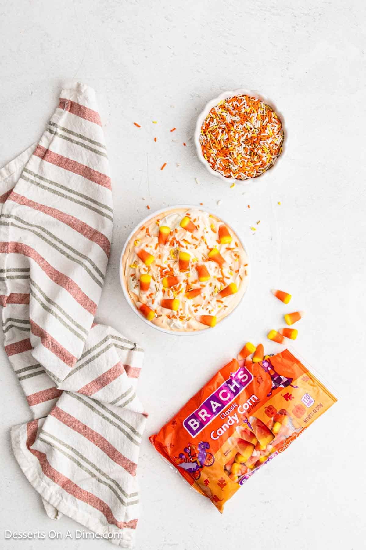 Candy corn and sprinkles added to top of tip in a serving bowl.