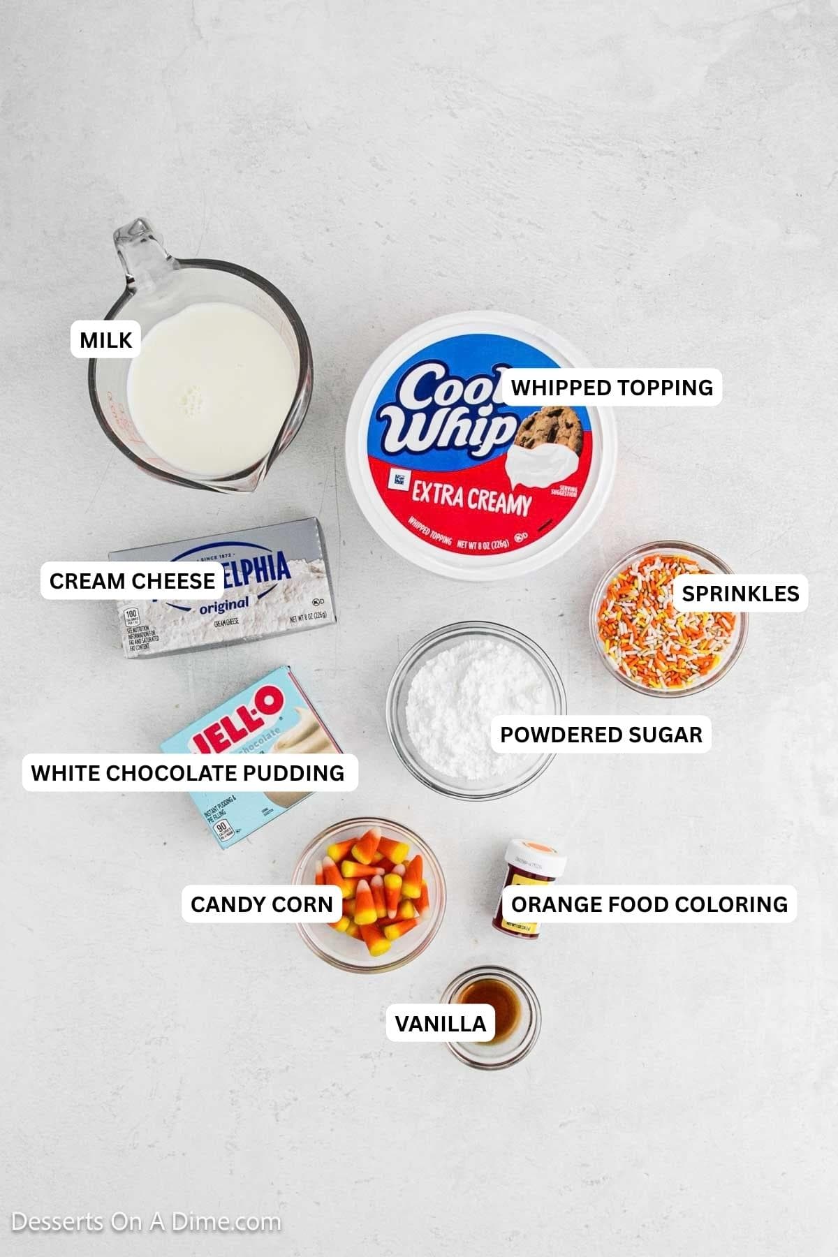 Ingredients for recipe: vanilla, candy corn, orange food coloring, white chocolate pudding, powdered sugar, sprinkles, cream cheese, whipped topping and milk.